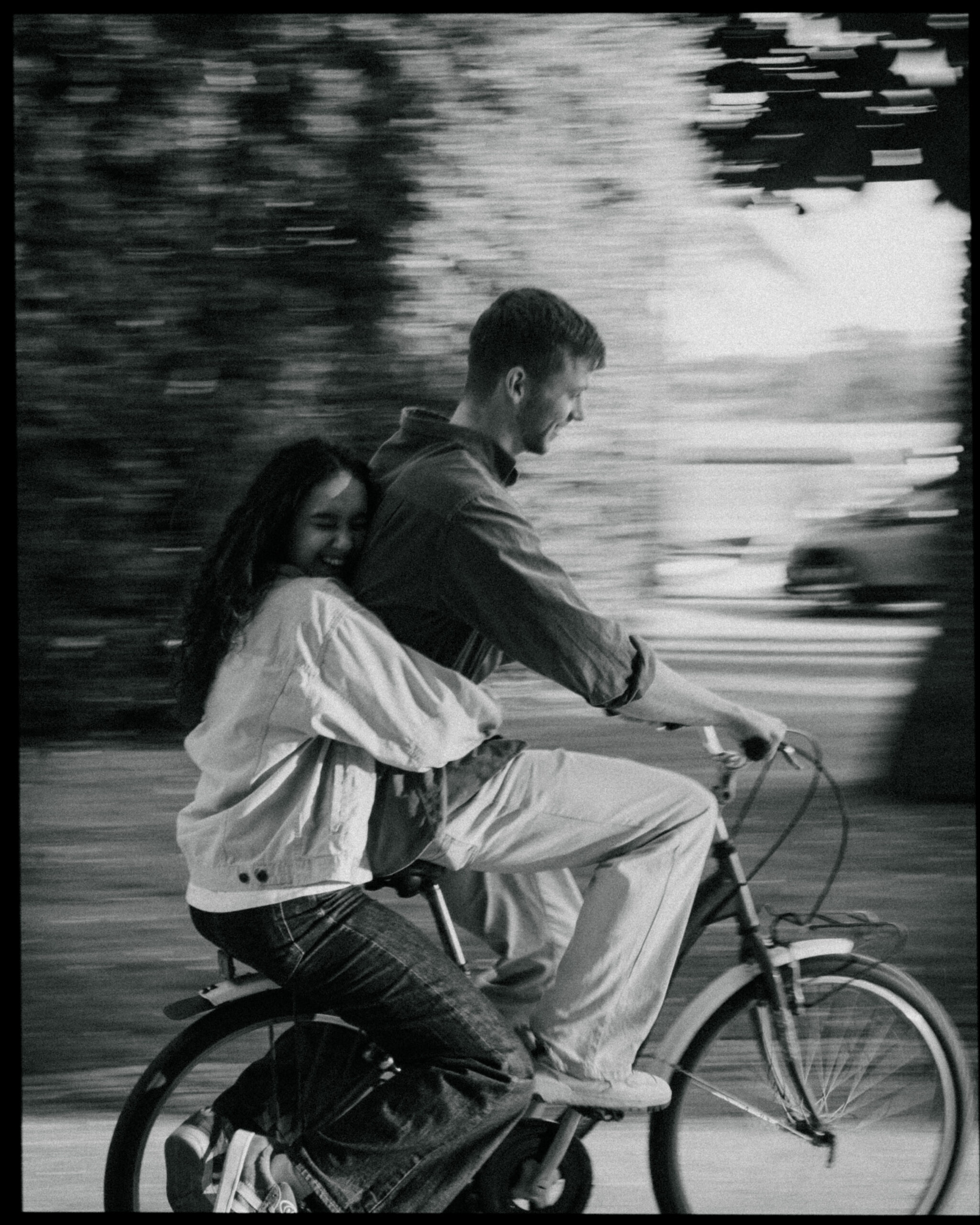 A cinematic photo of a couple on a bike in Porto.