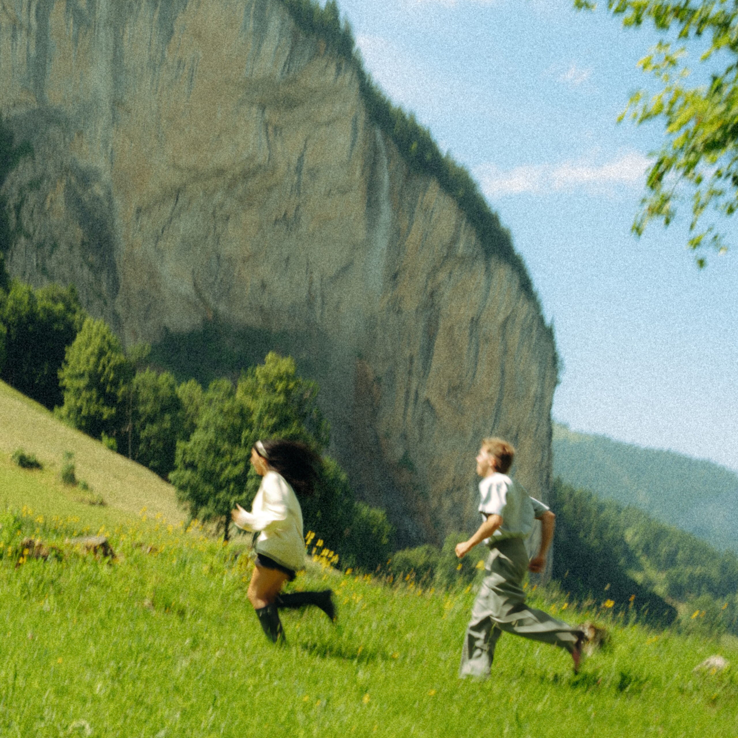 A cinematic photo of a couple running near the Swiss Alps.