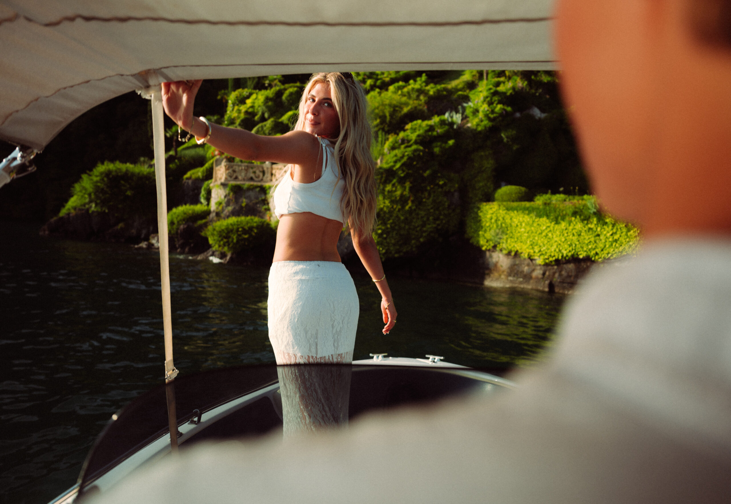 A cinematic photo of a couple posing in a boat in Lake Como.