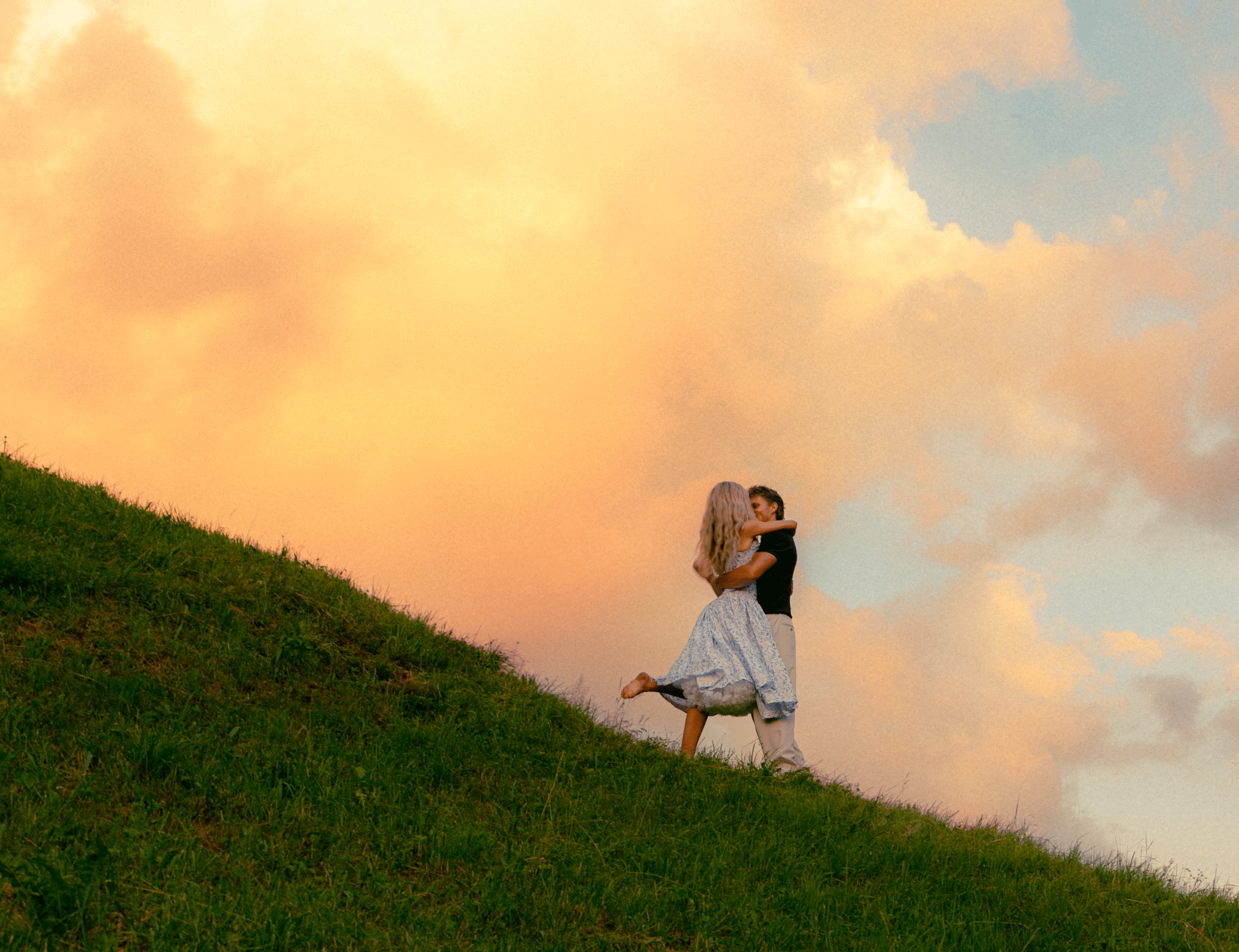 A cinematic epic photo of a couple kissing in a meadow near the Swiss Alps.