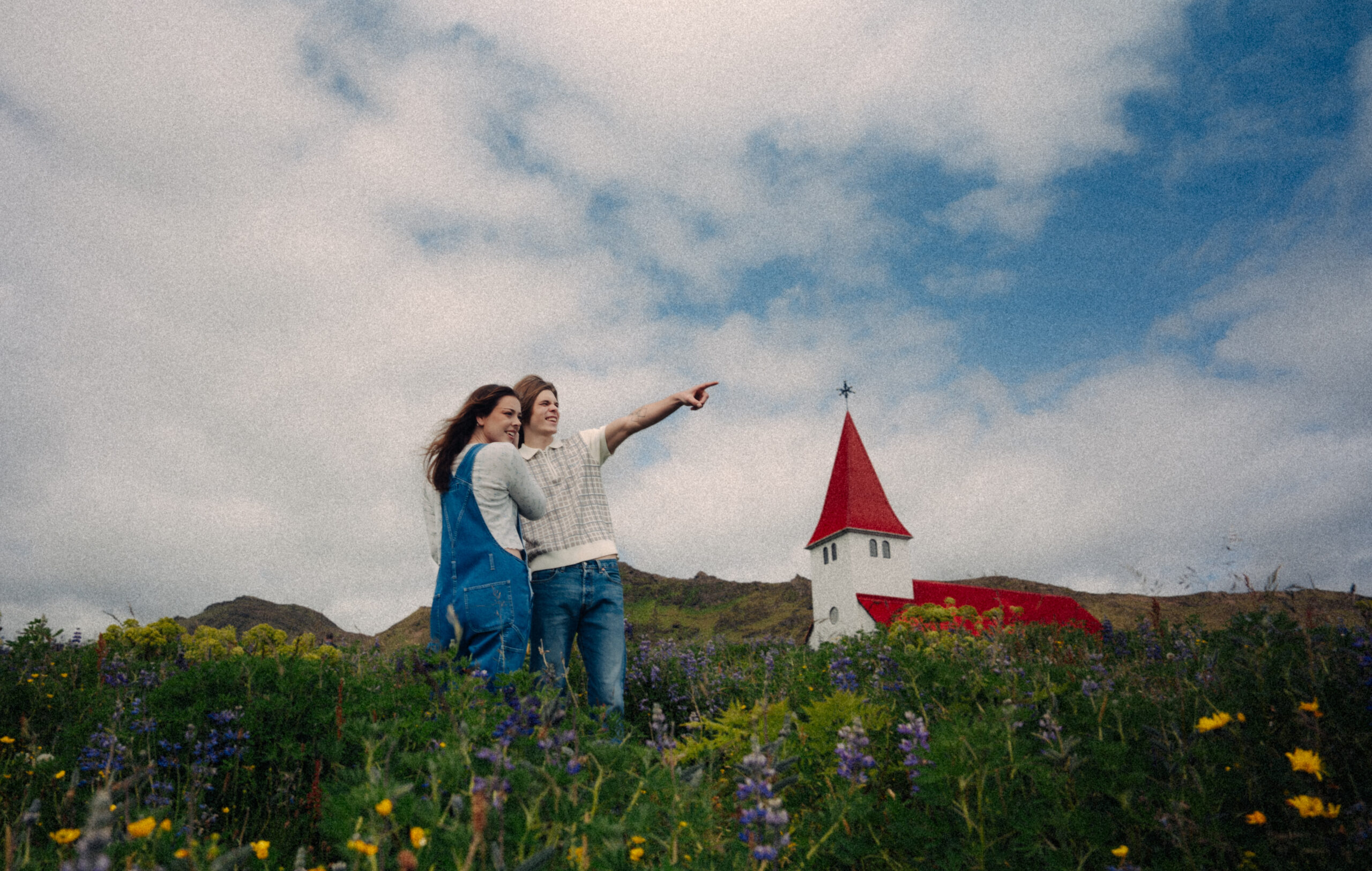 A cinematic photo of a couple posing in Vik, Iceland.