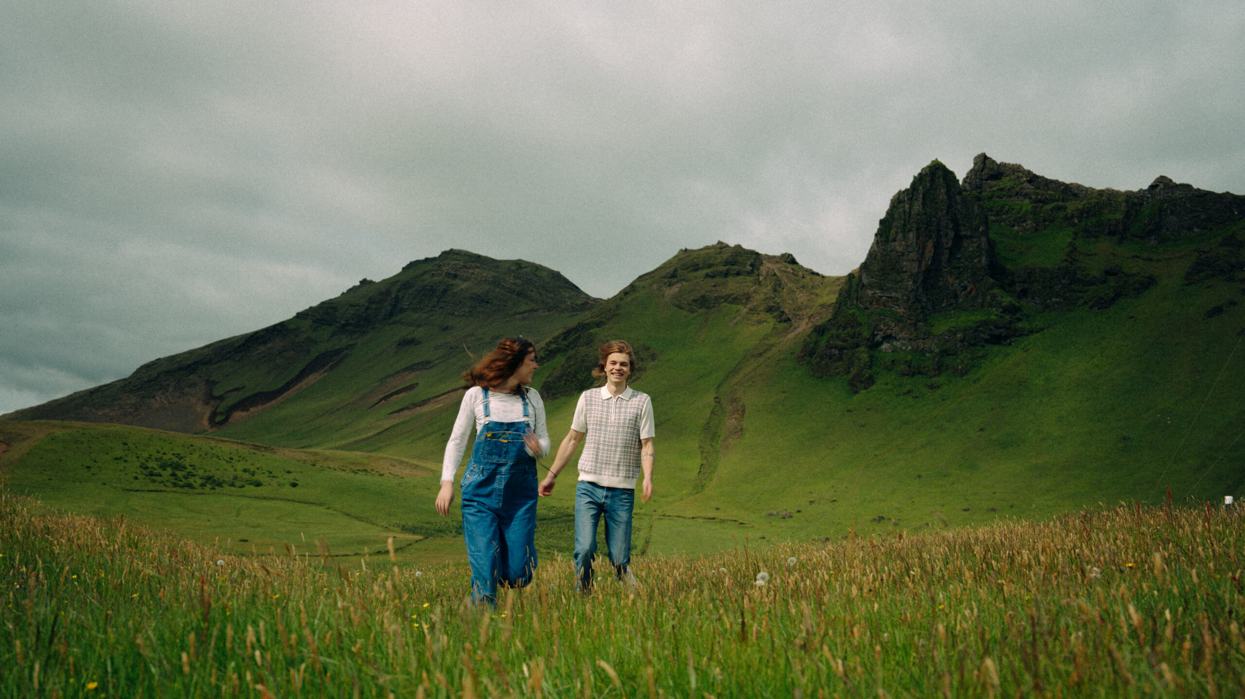 A cinematic photo of a couple posing in Vik, Iceland.