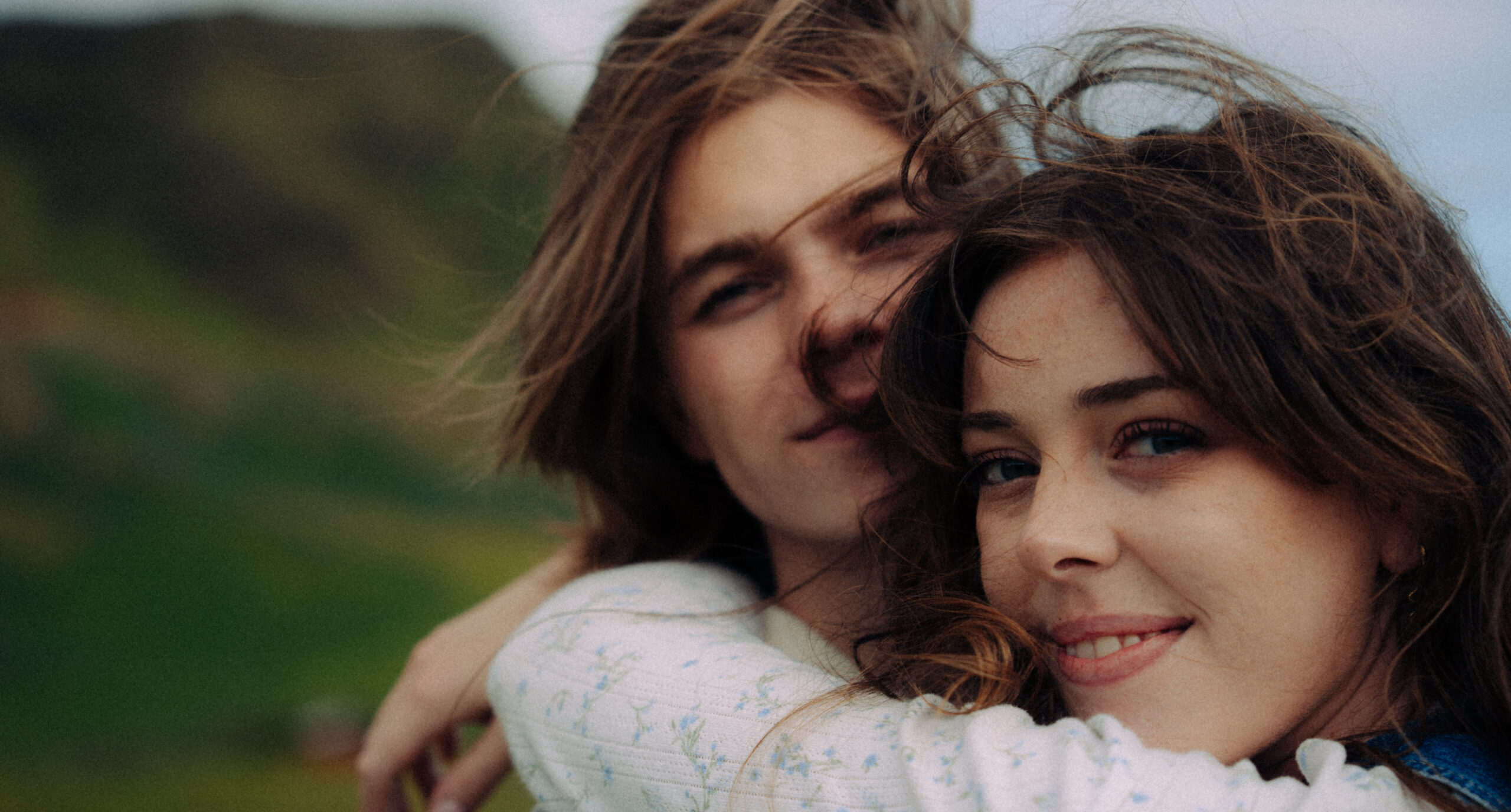 A cinematic photo of a couple posing in Vik, Iceland.