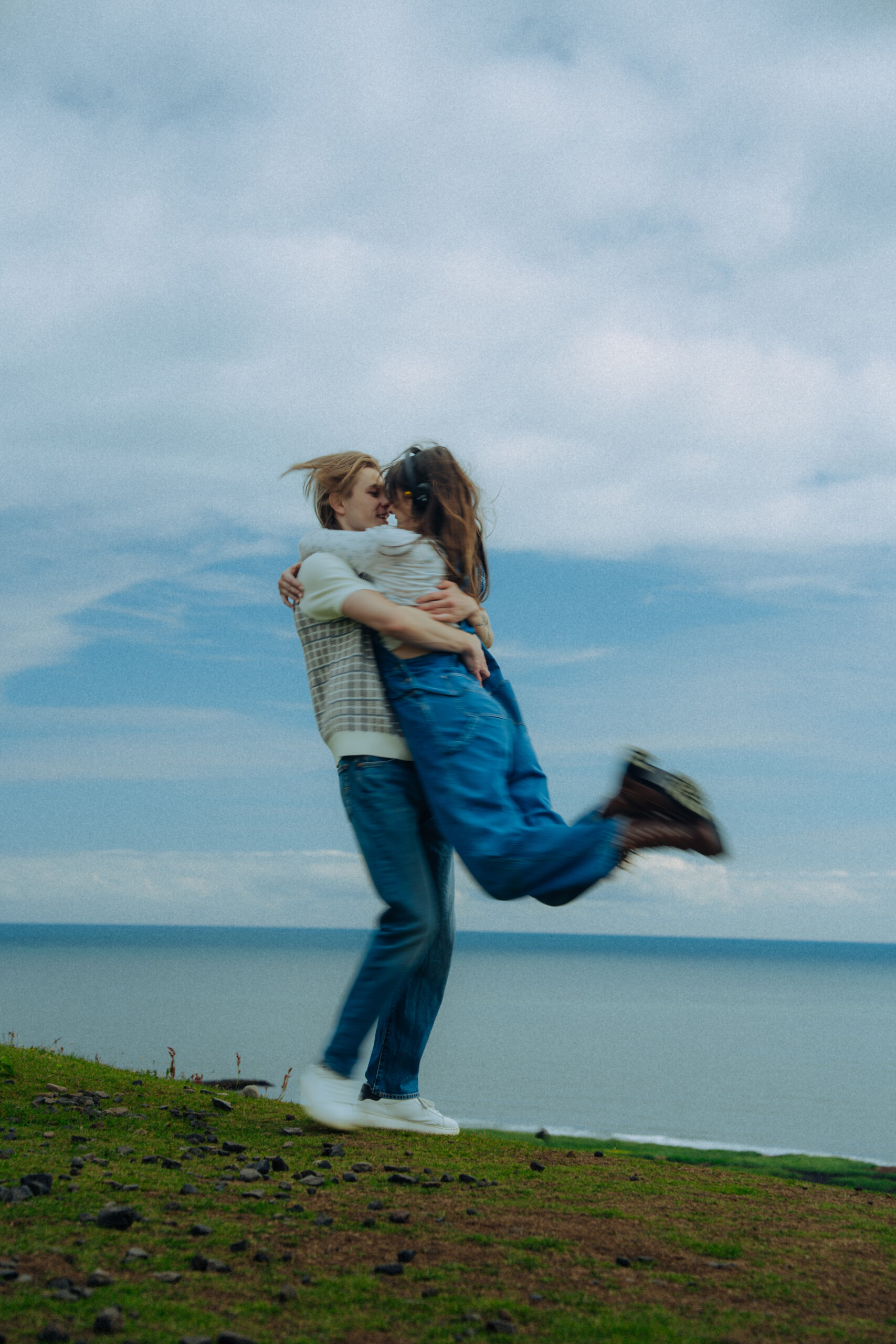 A cinematic photo of a couple posing in Vik, Iceland.
