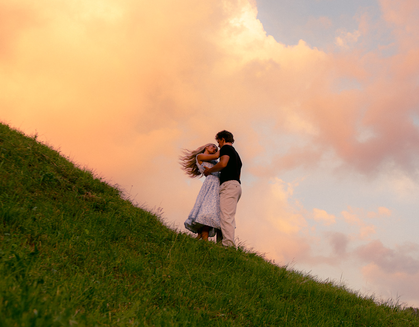 A cinematic epic photo of a couple in a meadow near the Swiss Alps.