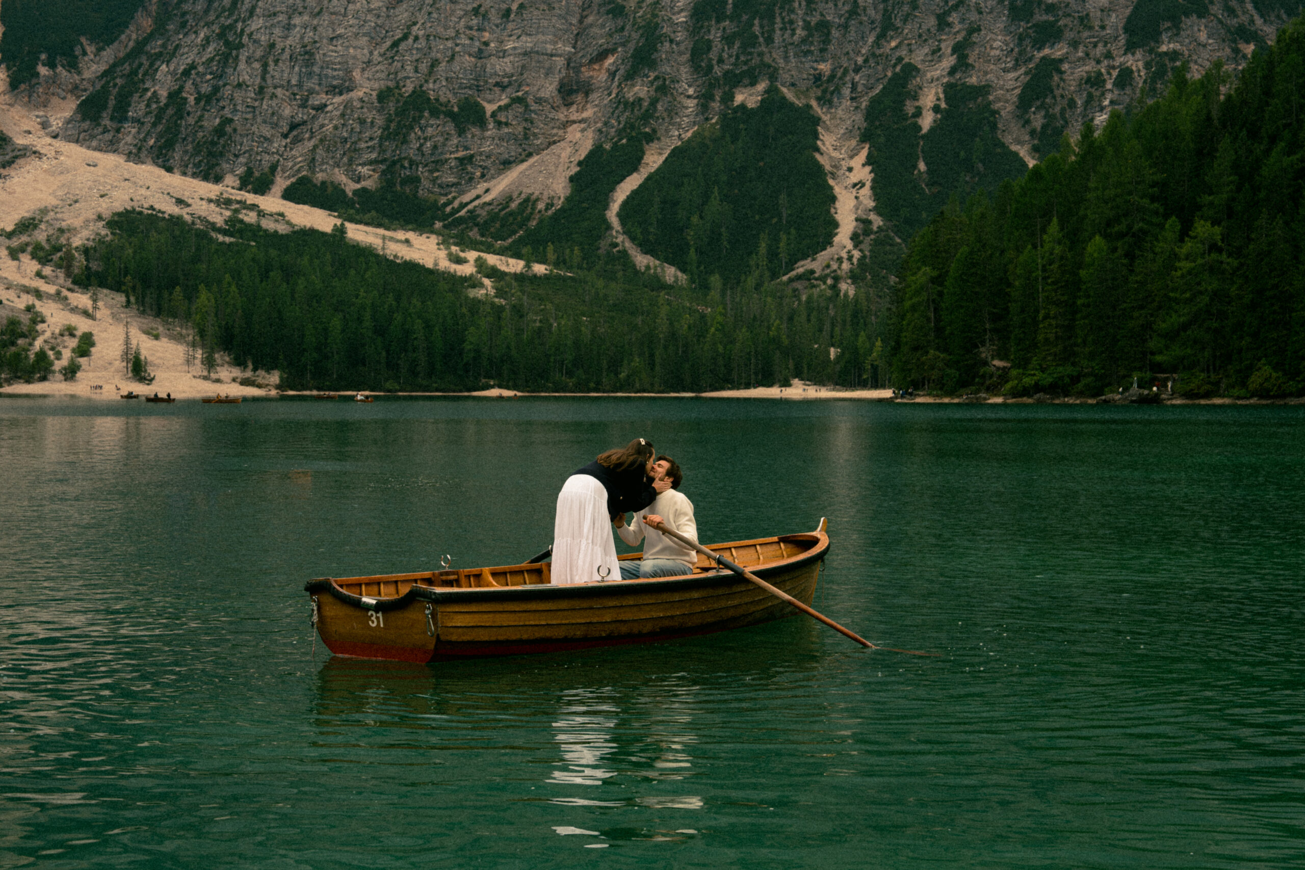 A cinematic photo of a couple in Lake Braies in Italy taken during one of the European elopements.