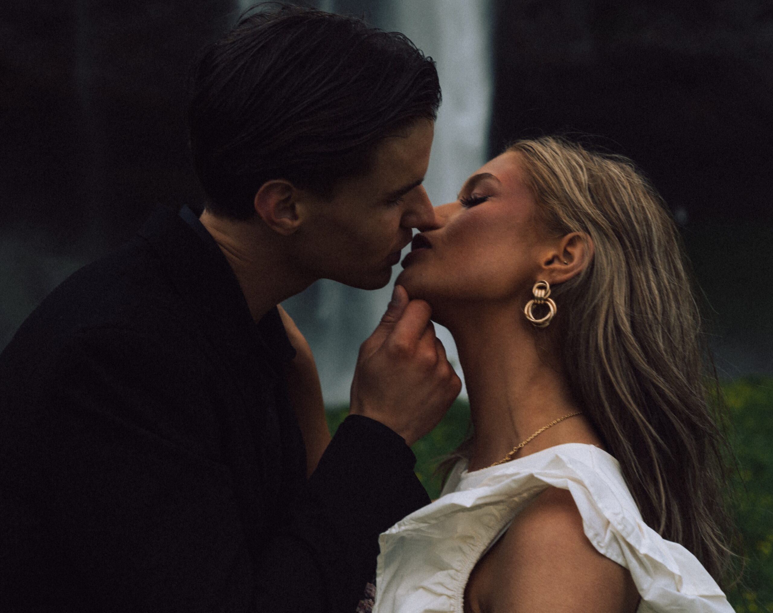 A cinematic photo of a couple in front of a waterfall during their elopement in Iceland.