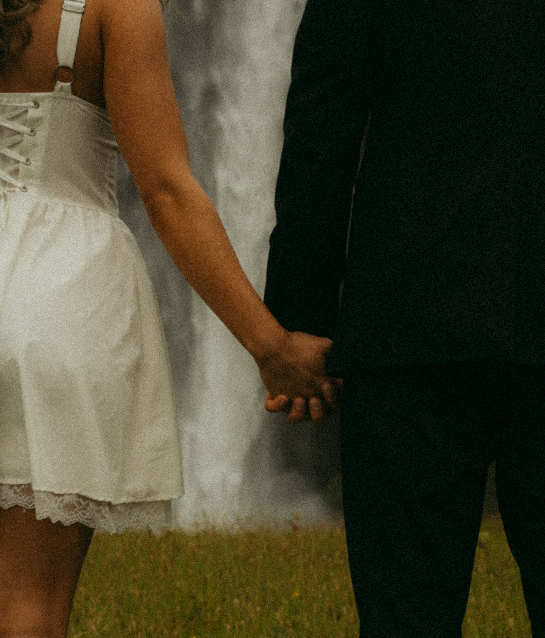 A cinematic photo of a couple in front of a waterfall during their elopement in Iceland.