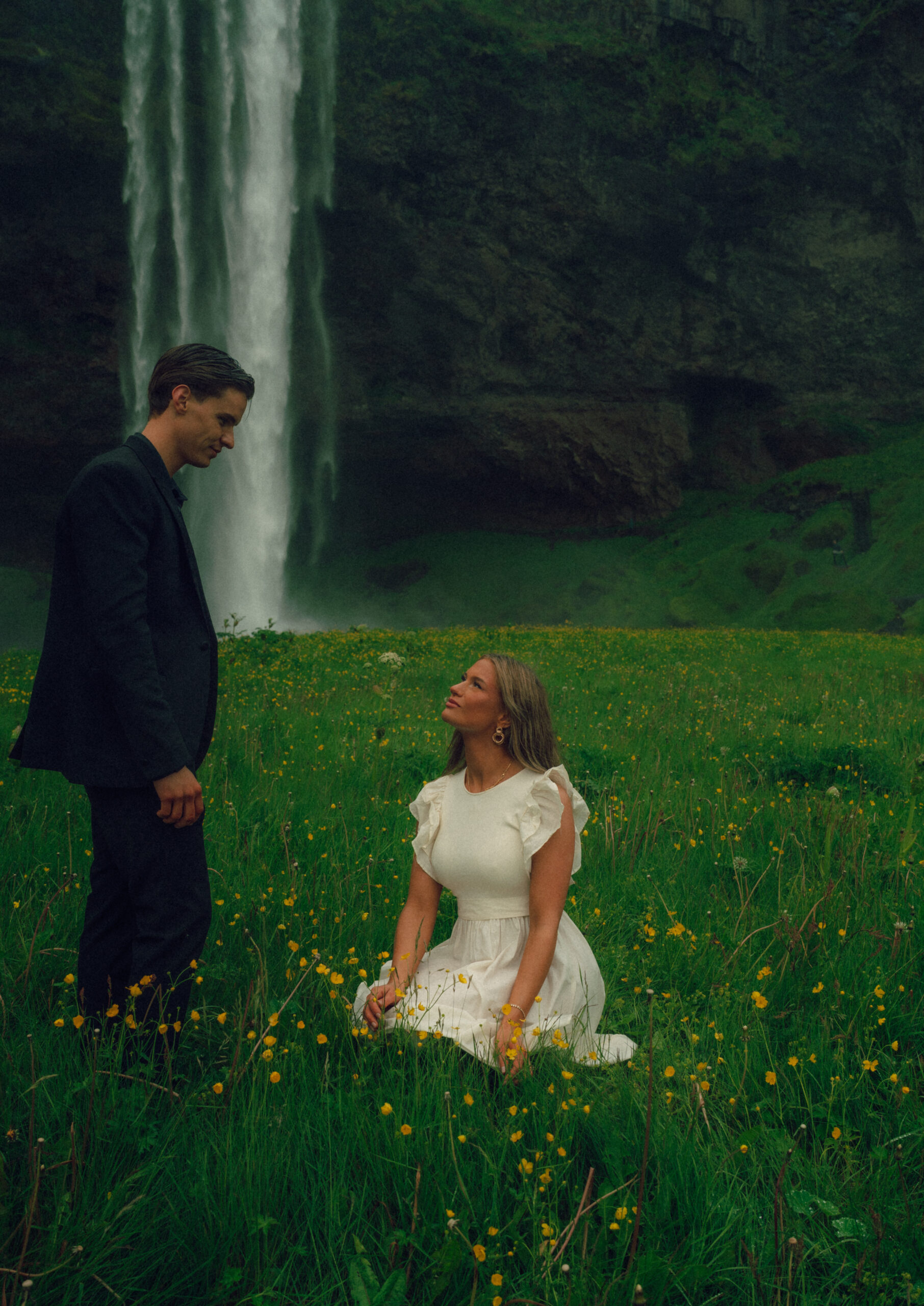 A cinematic photo of a couple in front of a waterfall during their elopement in Iceland.