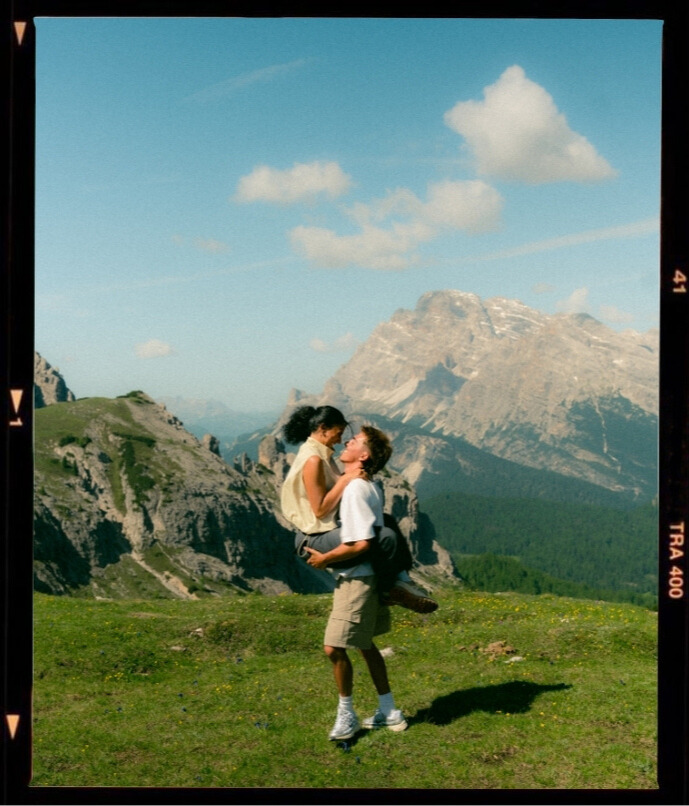 A cinematic photo of a couple posing in Italy.