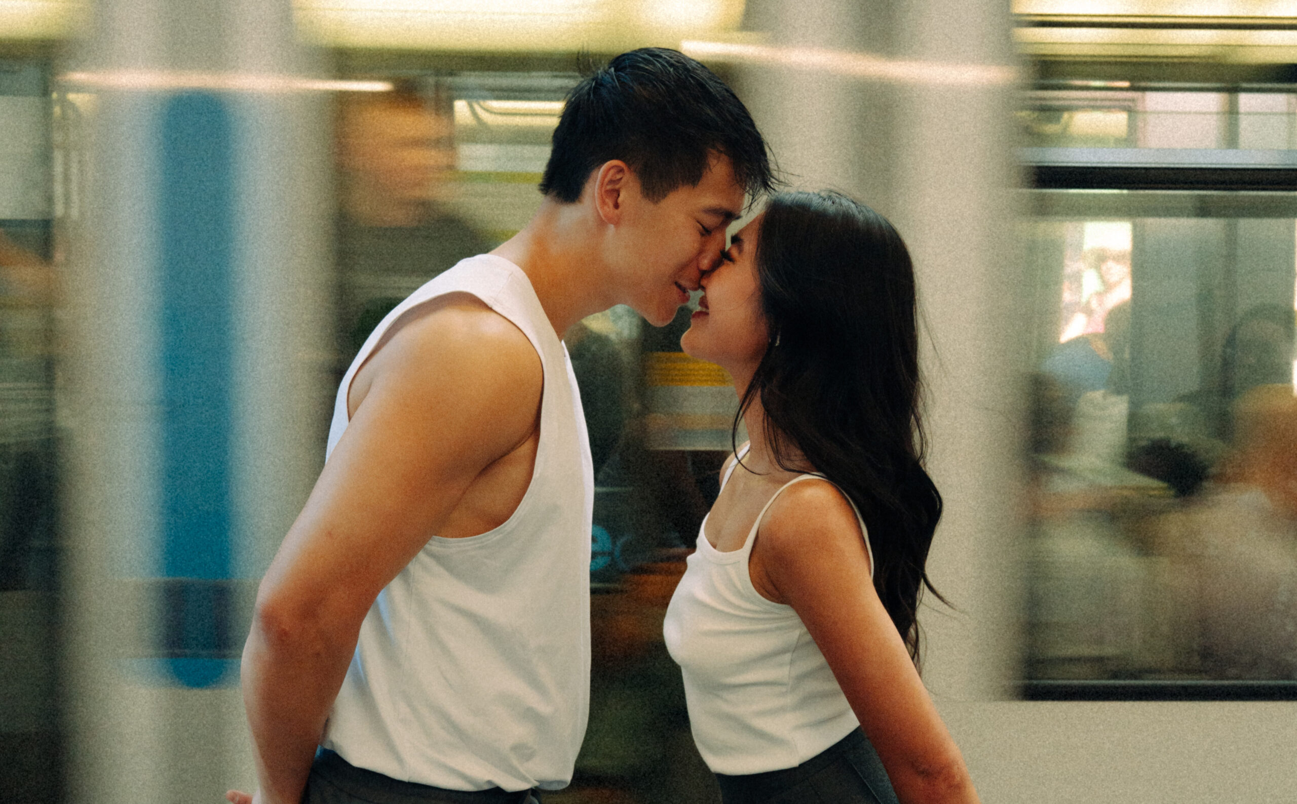 A cinematic photo of a couple posing in Paris metro.