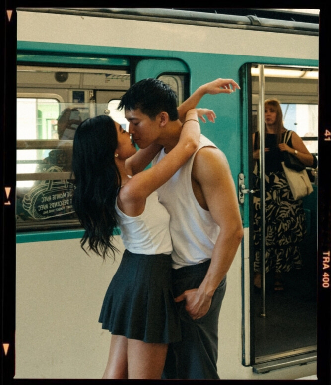 A cinematic photo of a couple posing in Paris metro.