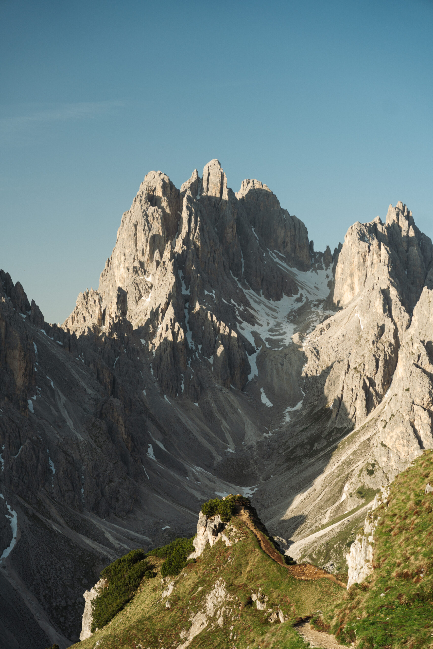 A cinematic epic photo of a couple posing with the Dolomites in the background.
