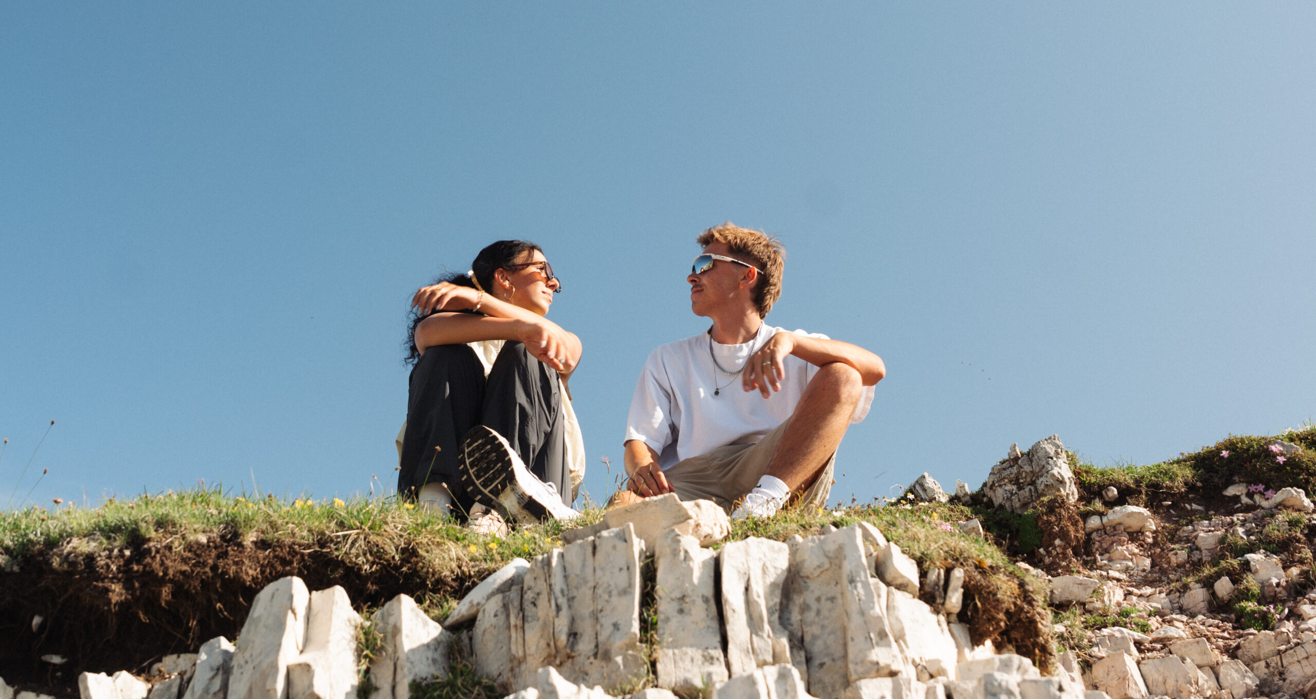A cinematic photo of a couple posing near the Dolomites.