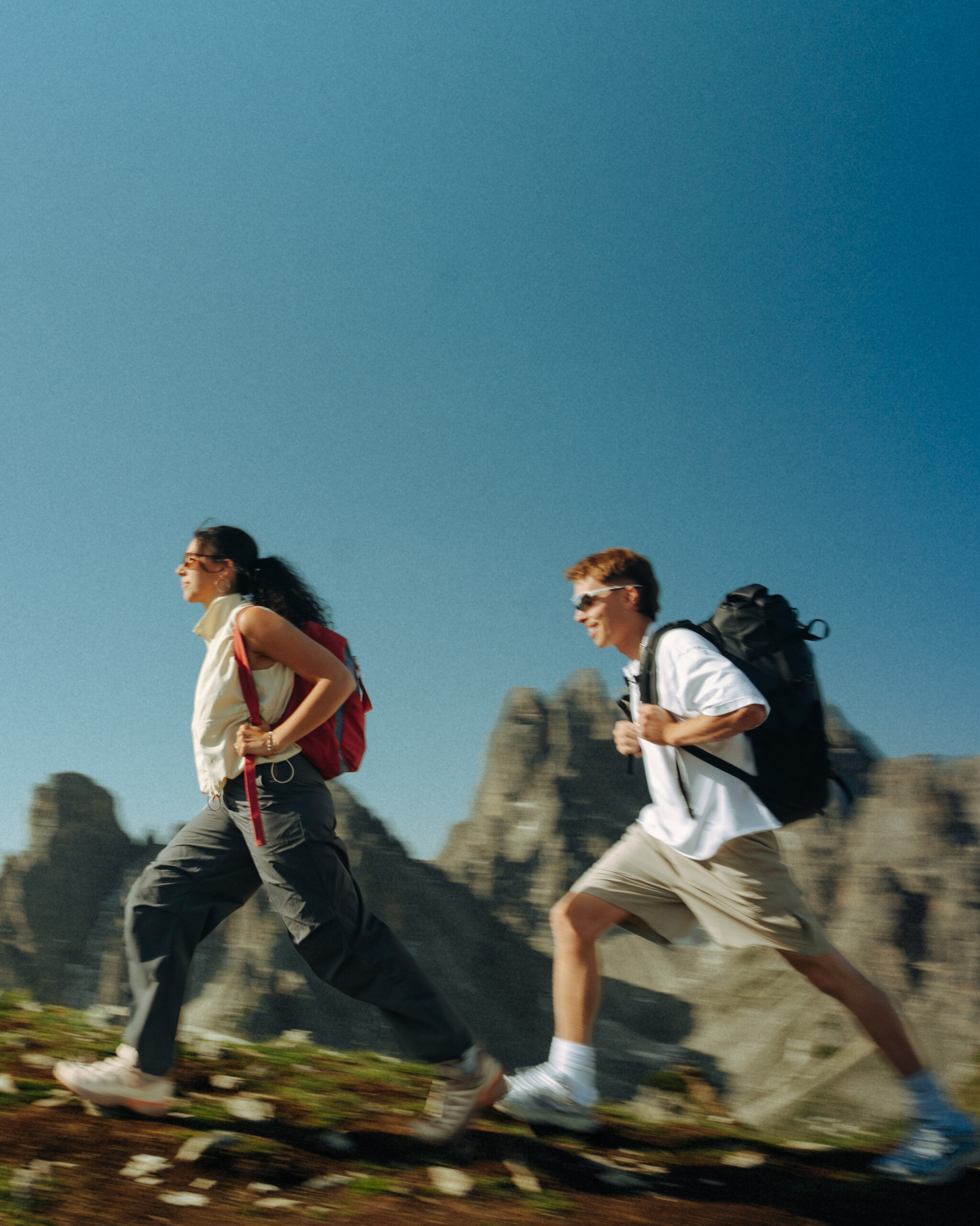 A cinematic photo of a couple posing with the Dolomites in the background.