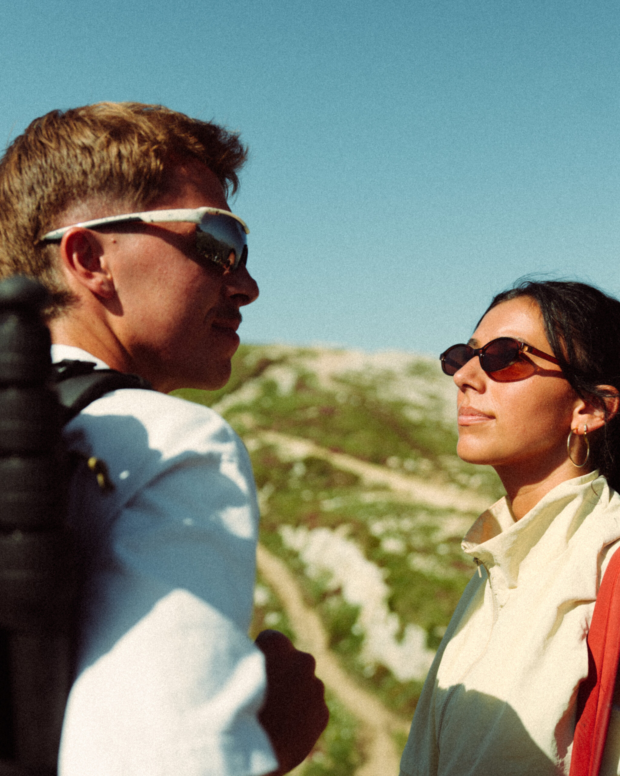 A cinematic photo of a couple posing near the Dolomites.