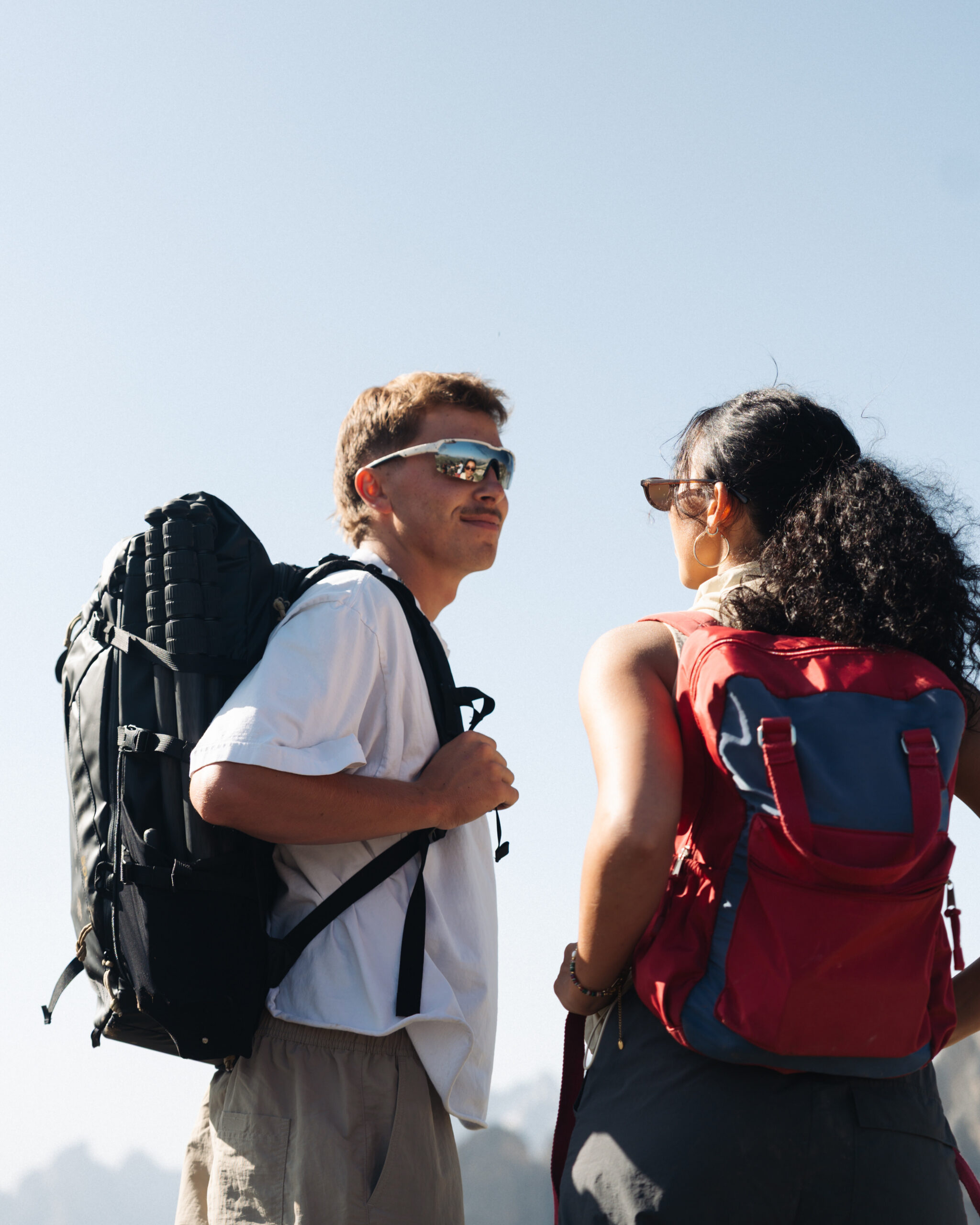 A cinematic photo of a couple posing near the Dolomites.