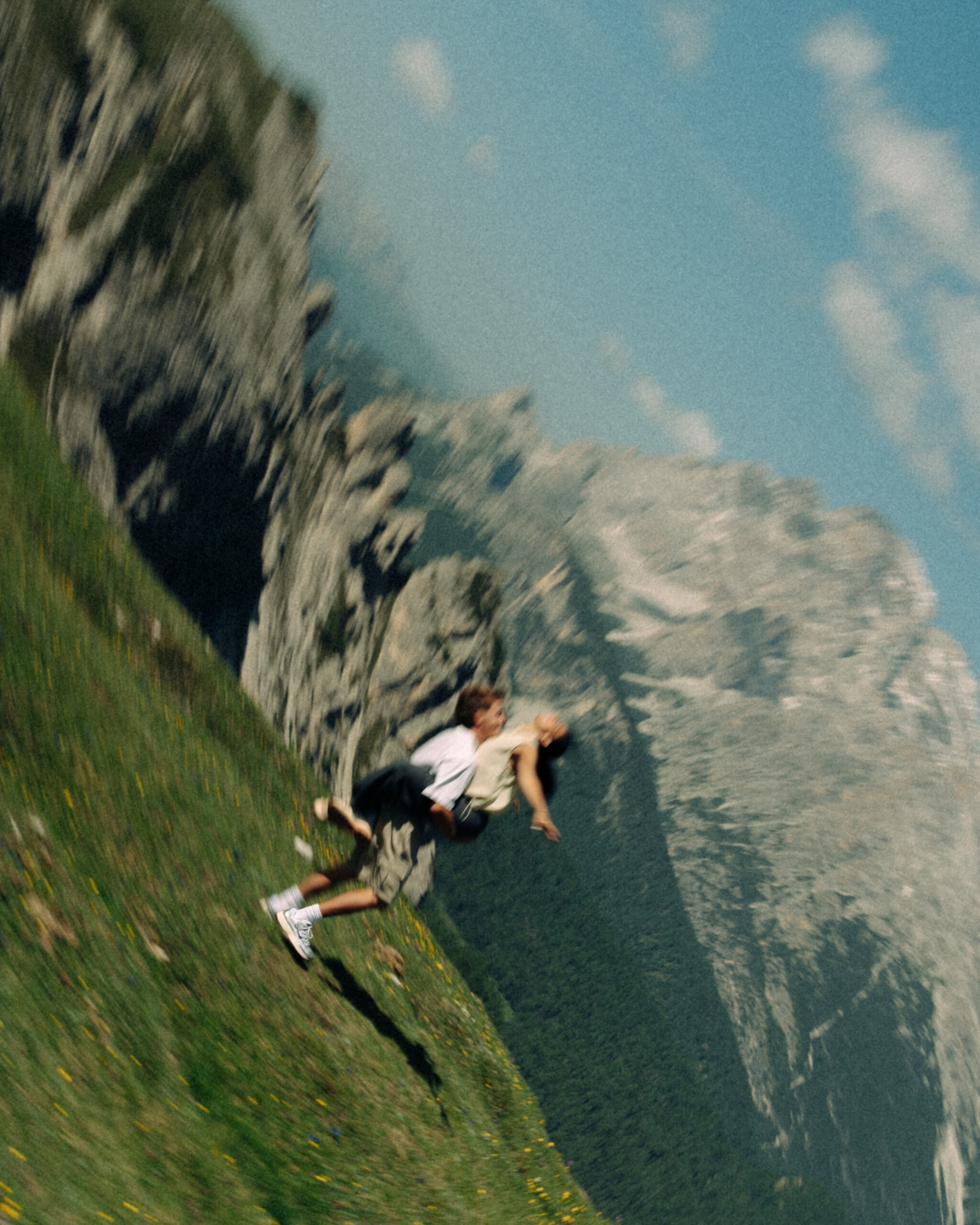 A cinematic photo of a couple posing with the Dolomites in the background.