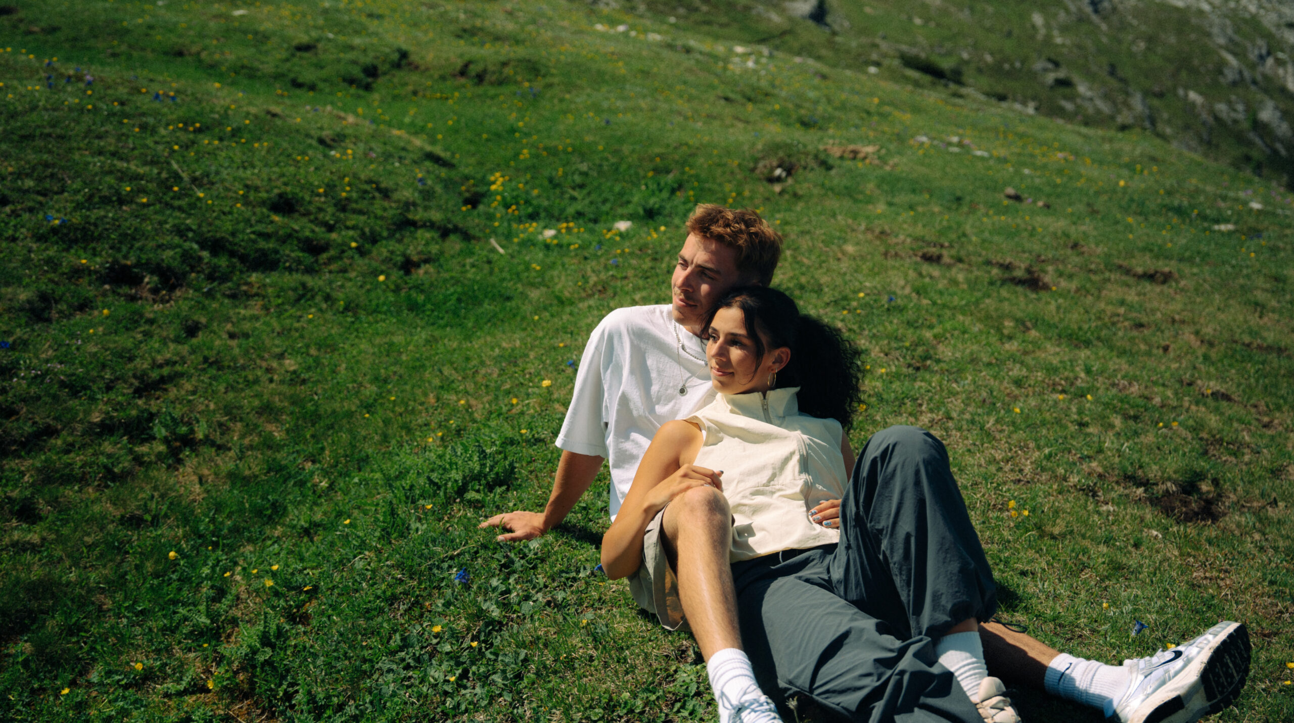 A cinematic photo of a couple posing near the Dolomites.