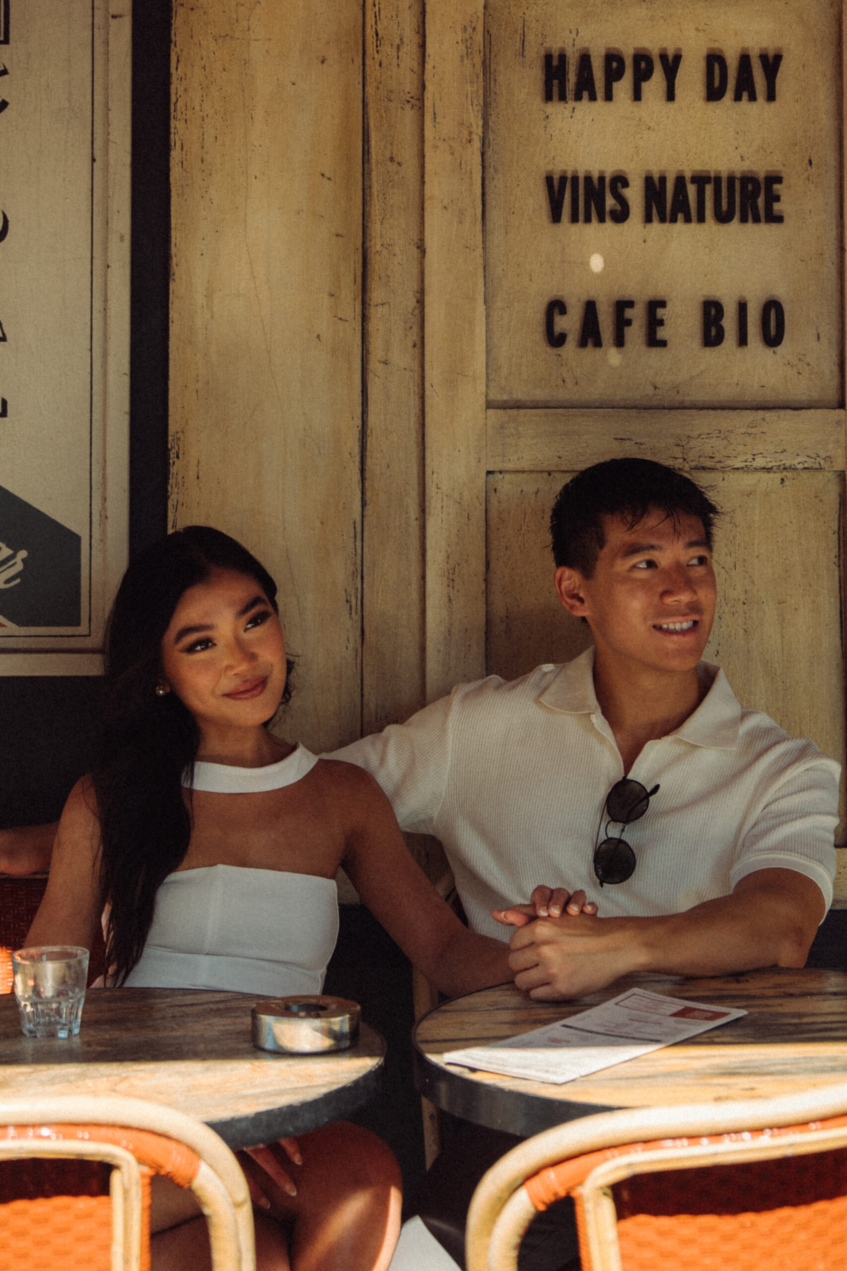 A cinematic photo of a couple posing in Paris.