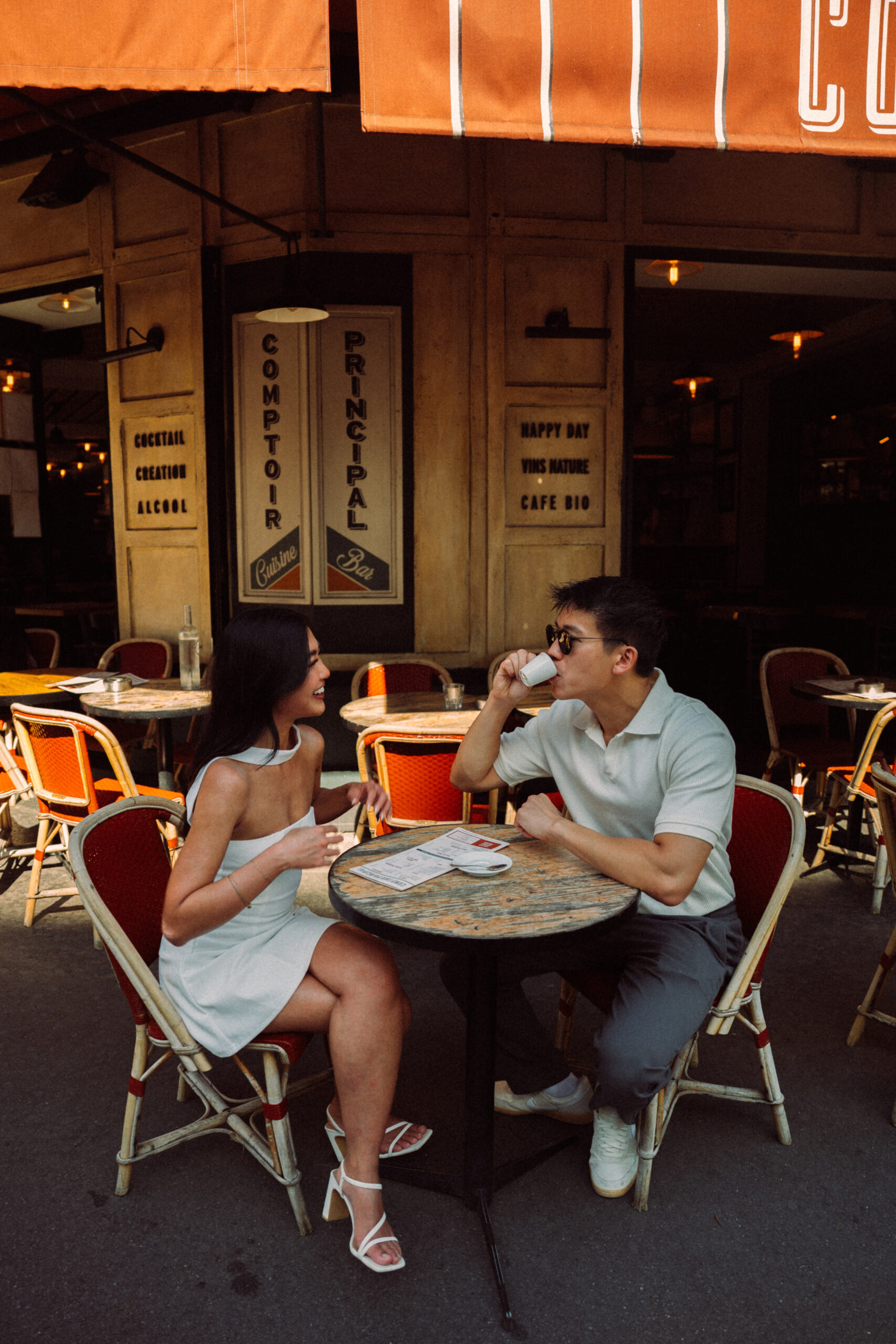 A cinematic photo of a couple in a cafe in Paris.