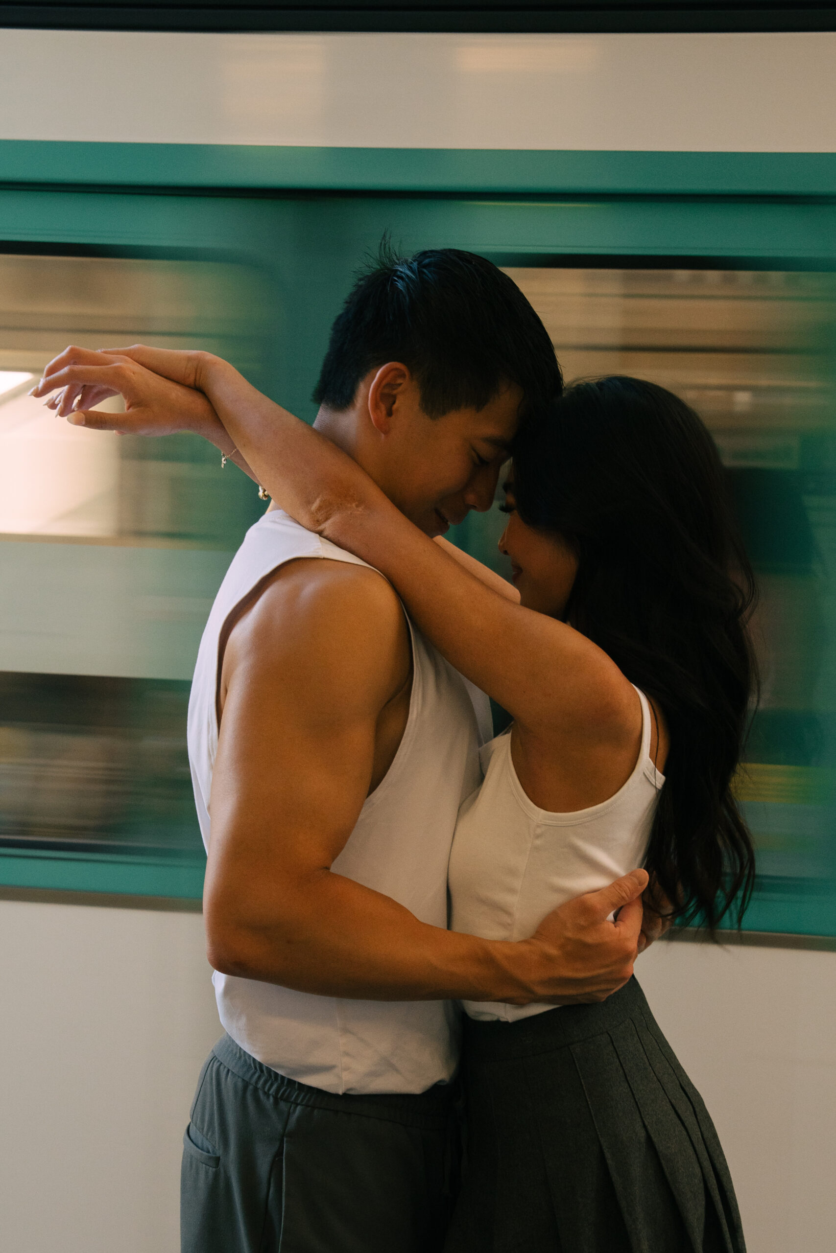 A cinematic photo of a couple posing in Paris metro.