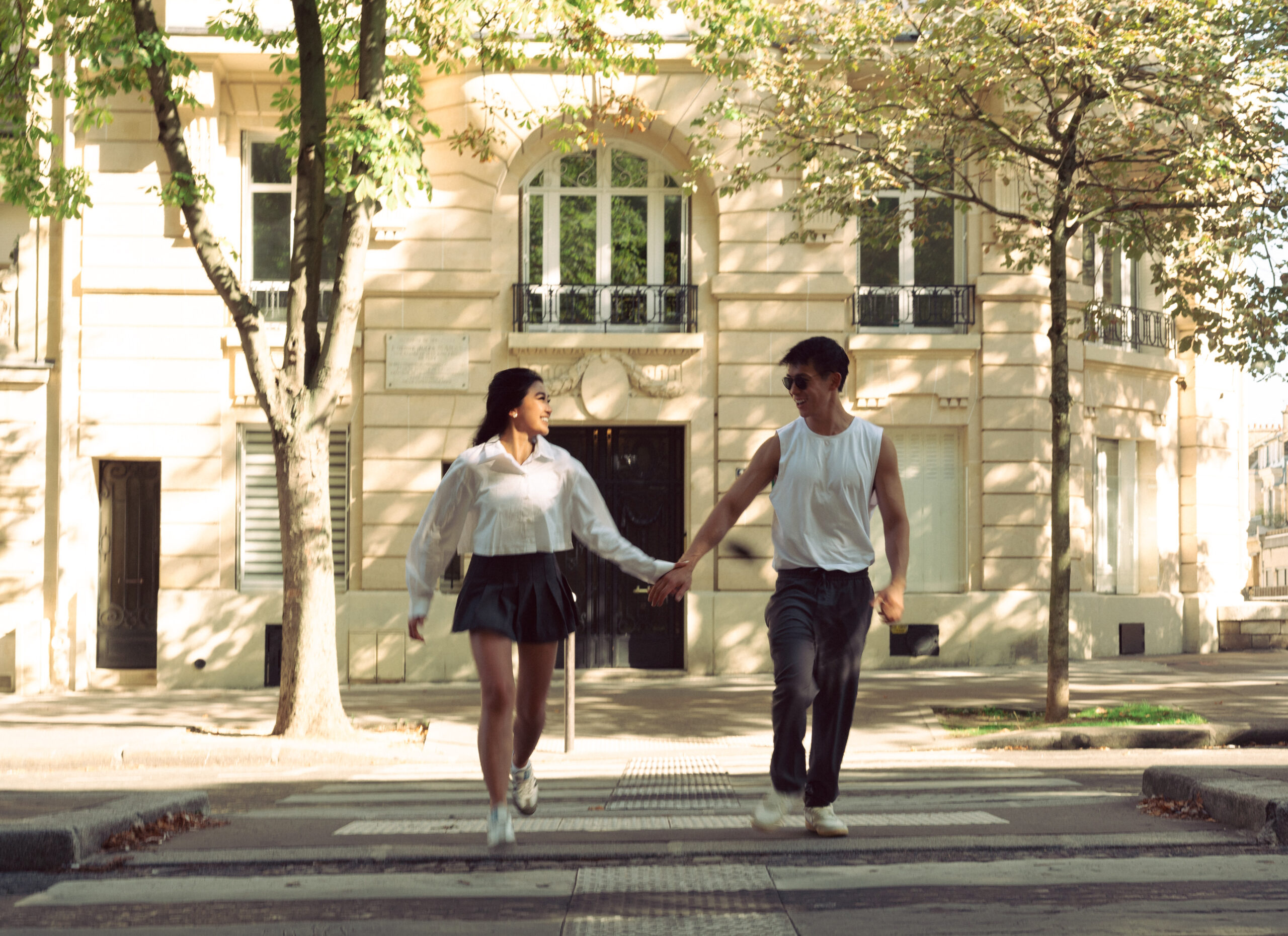 A cinematic photo of a couple posing in Paris.