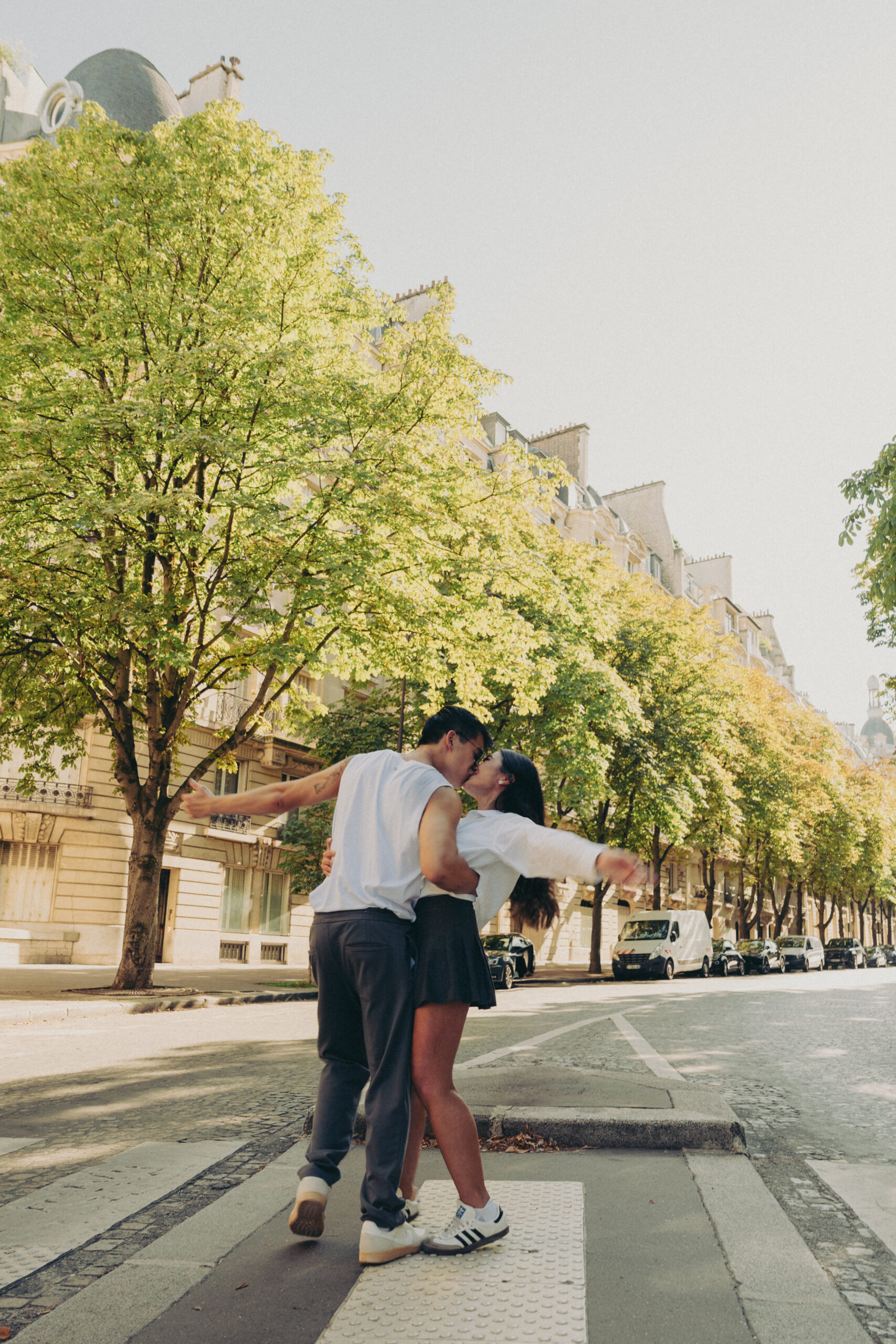 A cinematic photo of a couple posing in Paris.