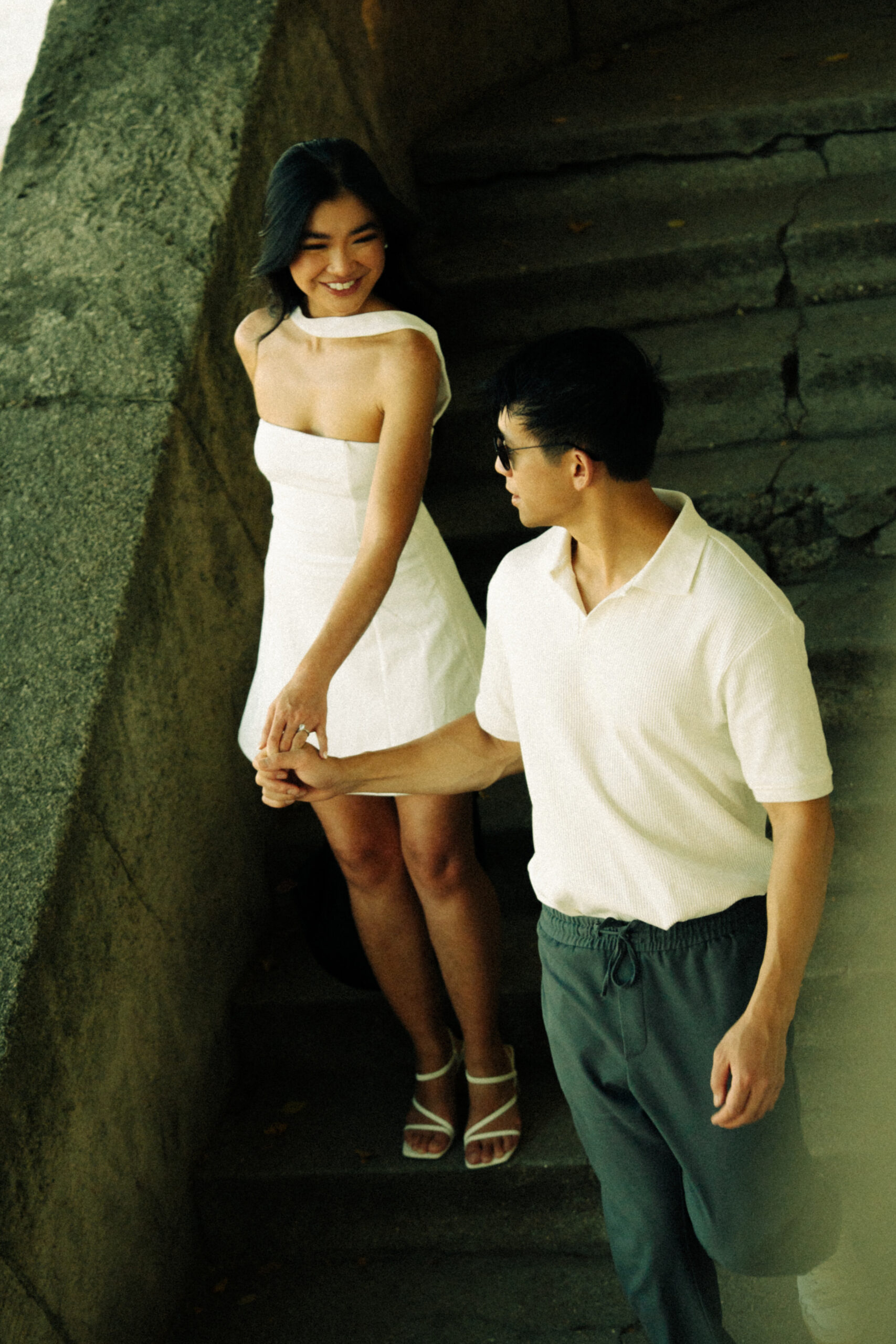 A cinematic photo of a couple posing in Paris.