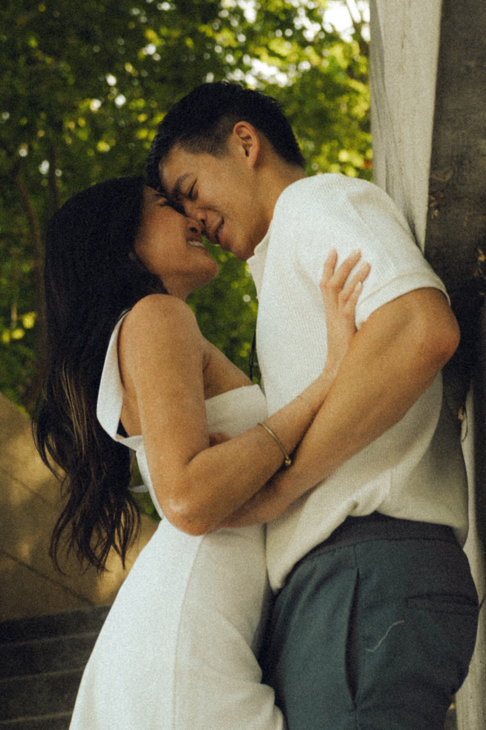 A cinematic photo of a couple posing in Paris.