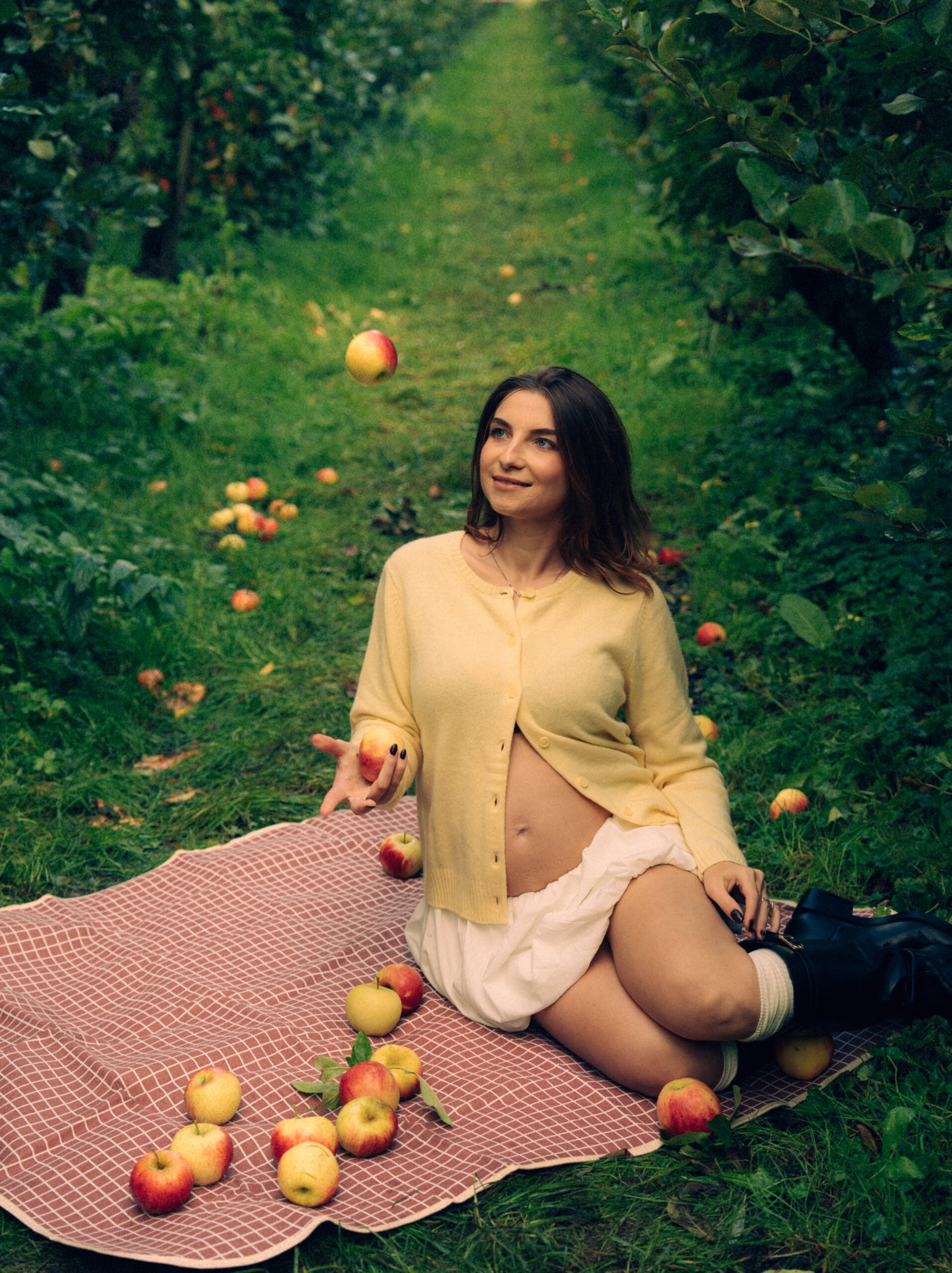 A cinematic photo of a couple at an apple orchard in the Netherlands.