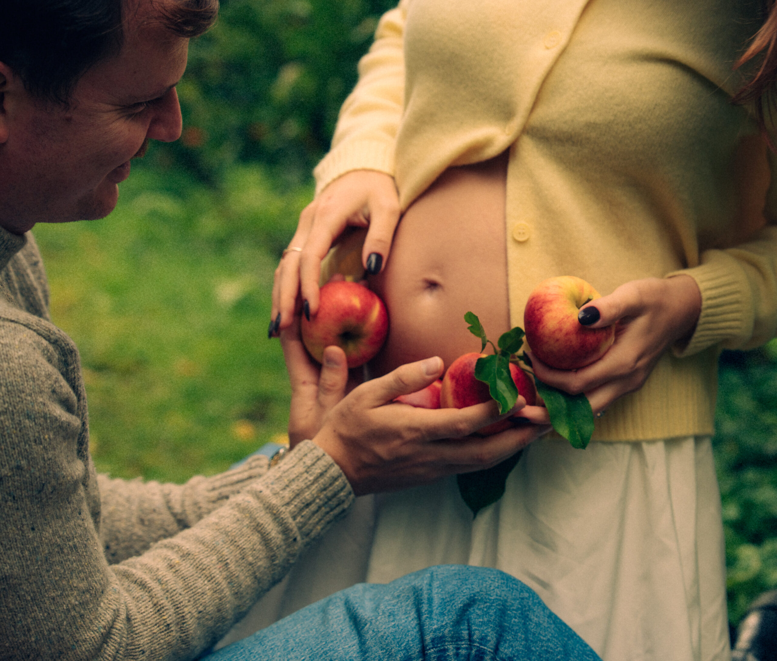 A cinematic photo of a couple at an apple orchard in the Netherlands.