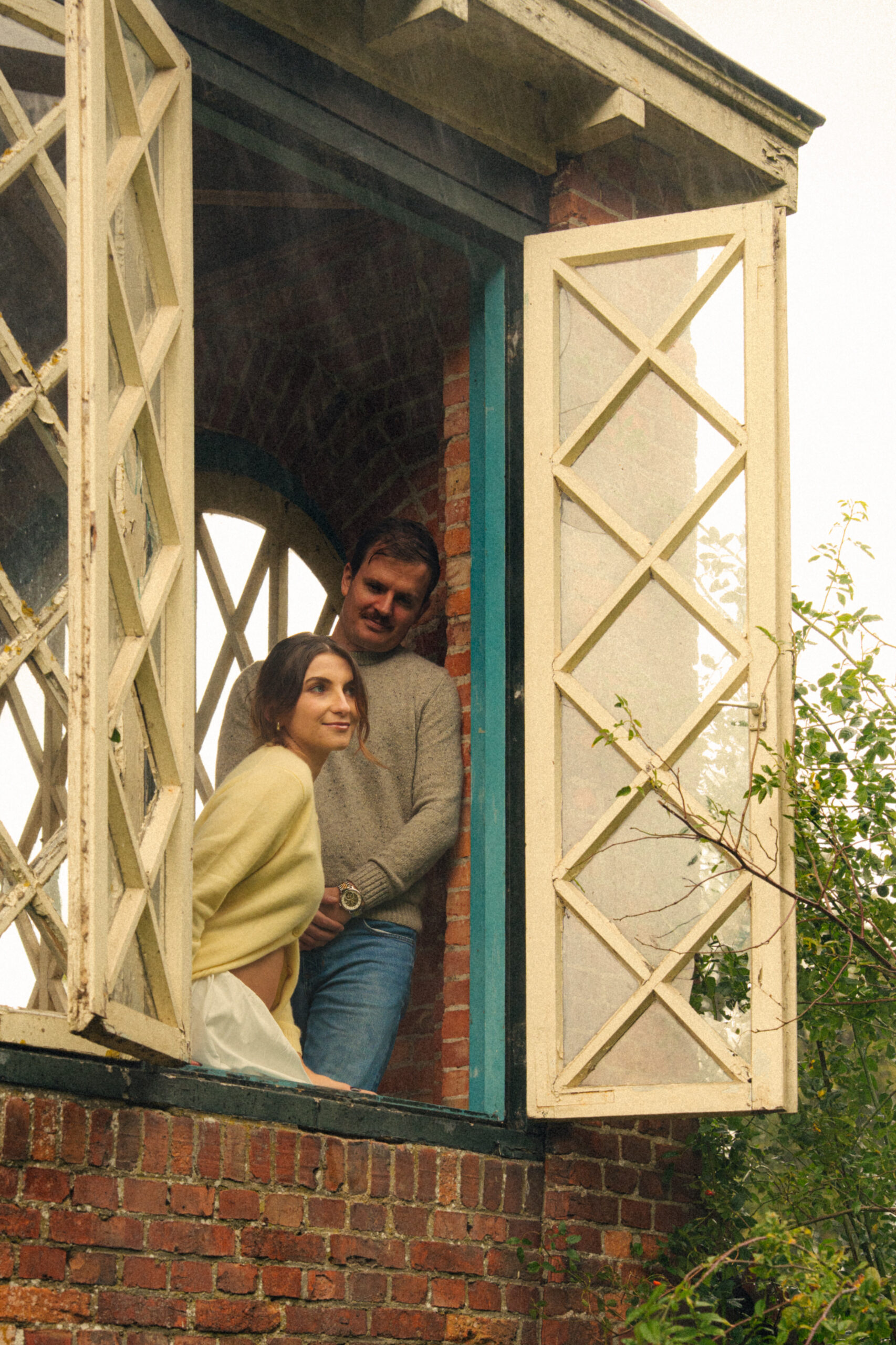 A cinematic photo of a couple at an apple orchard in the Netherlands.