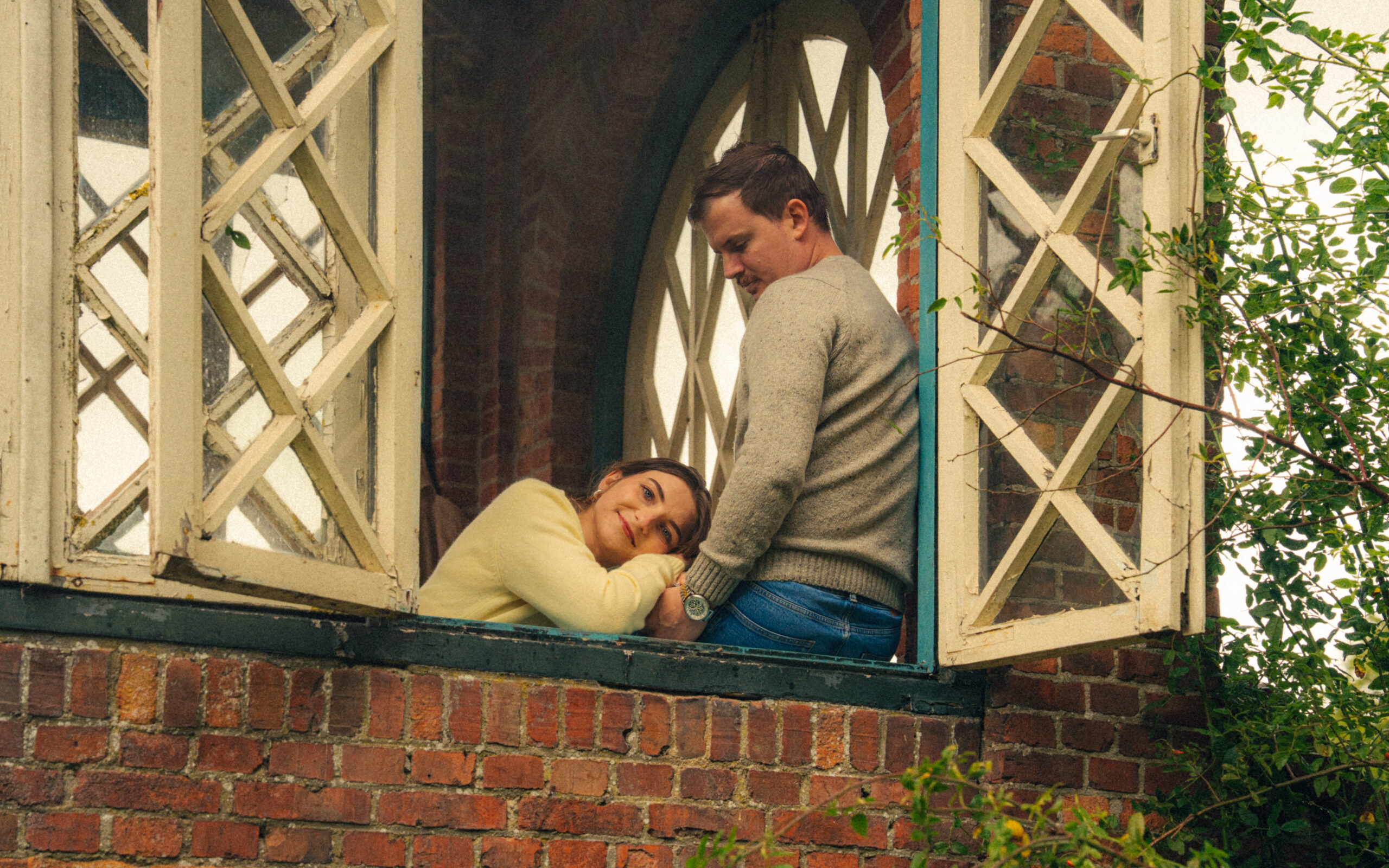 A cinematic photo of a couple at an apple orchard in the Netherlands.