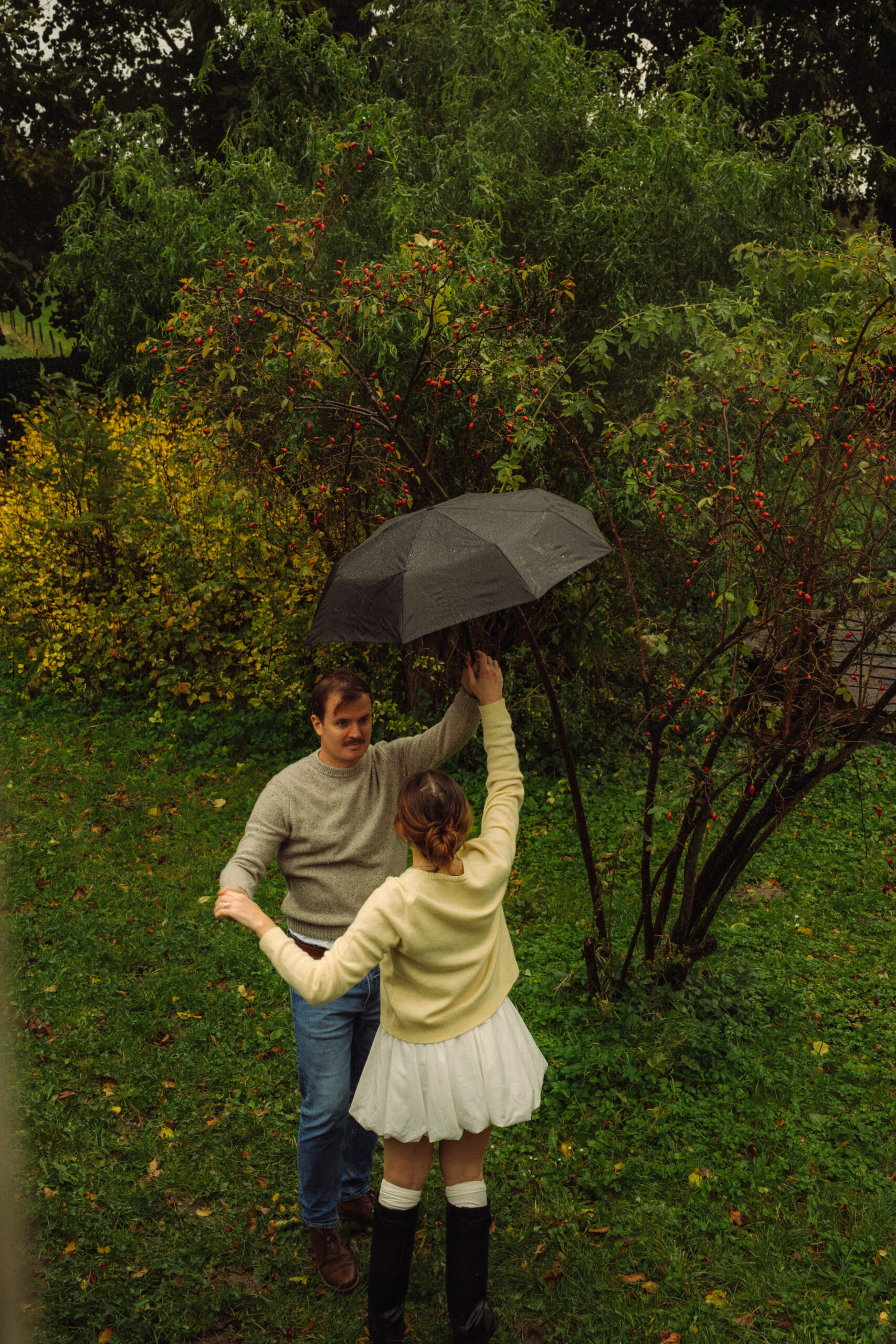 A cinematic photo of a couple at an apple orchard in the Netherlands.