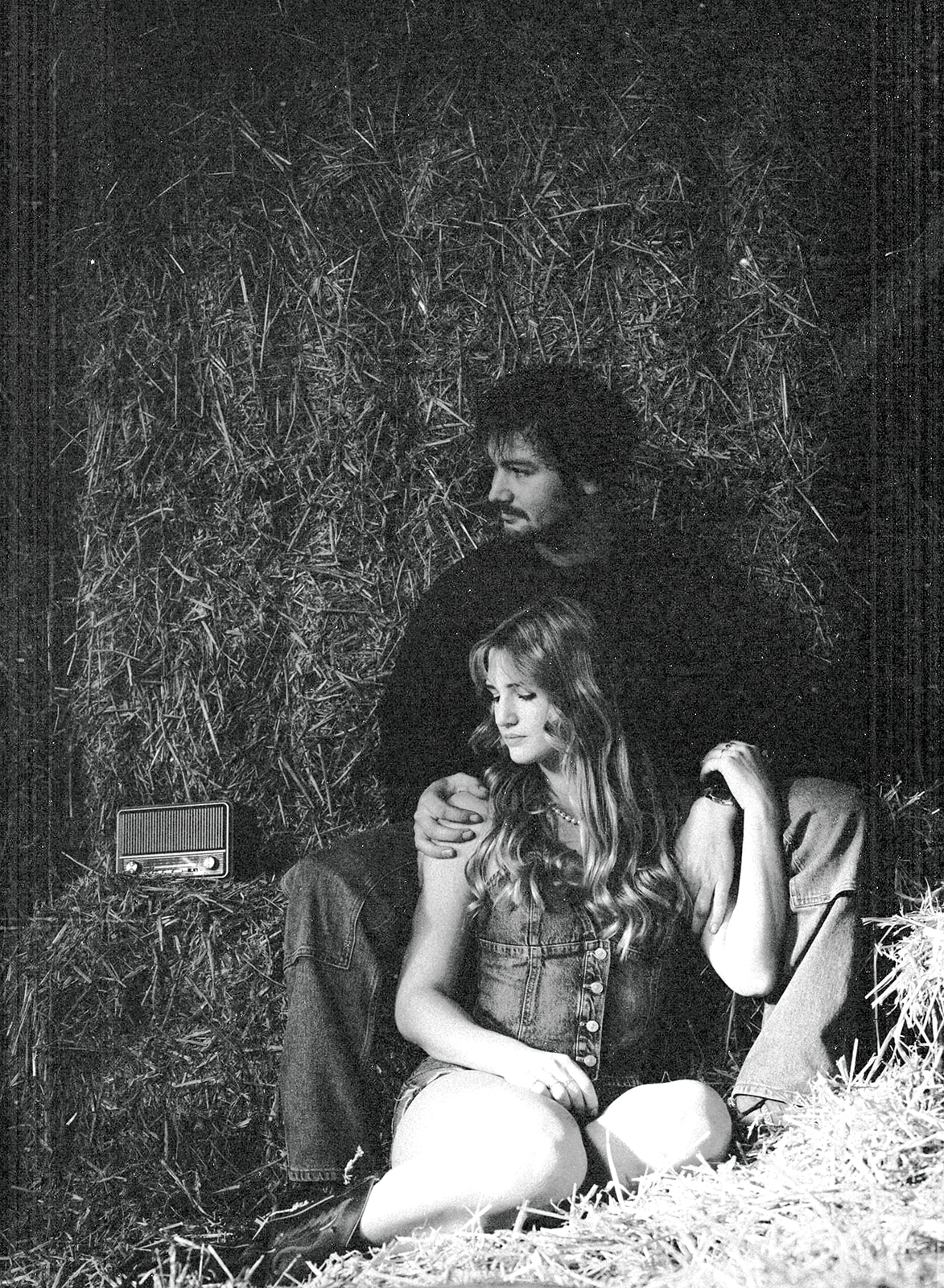 A cinematic photo of a couple in a farm's barn in the Netherlands.