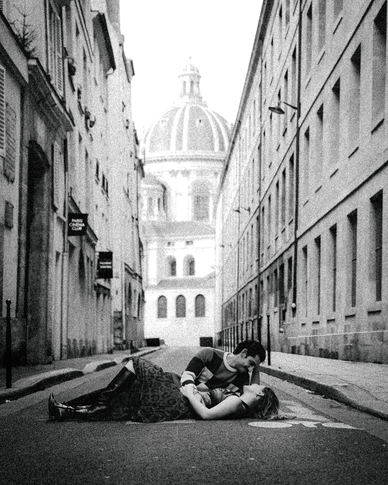 A cinematic photo of a couple posing in Paris.