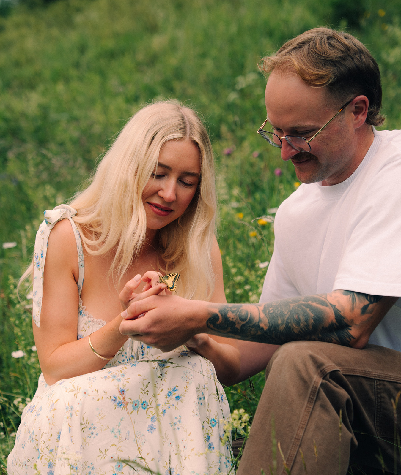 A cinematic photo of a couple with a butterfly near Wengen, Switzerland.