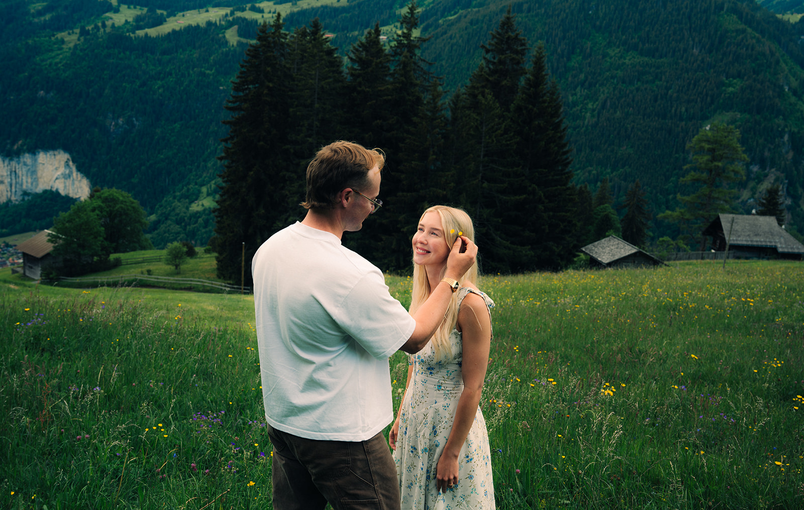 A cinematic photo of a couple posing near Wengen, Switzerland.
