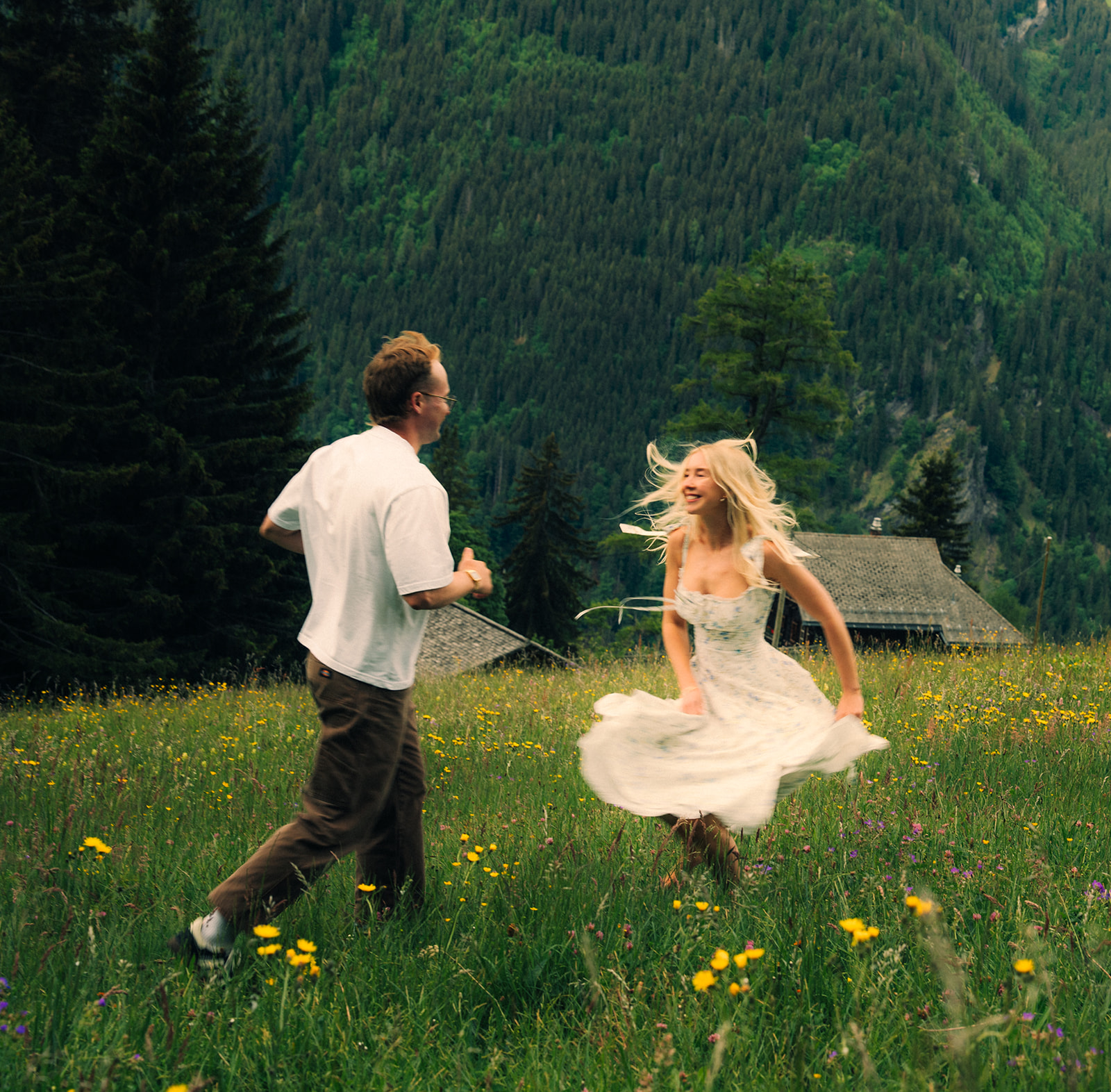 A cinematic photo of a couple posing near Wengen, Switzerland.