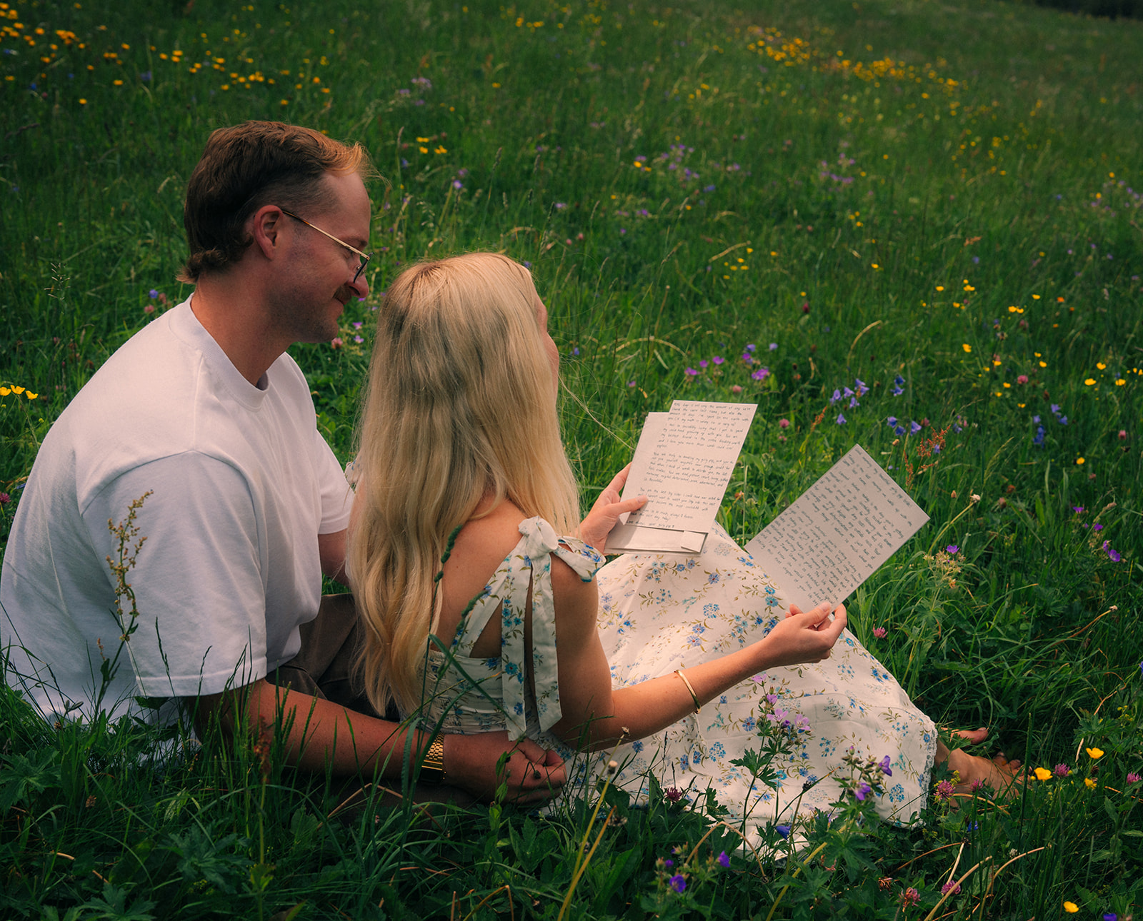 A cinematic photo of a couple reading letters near Wengen, Switzerland.