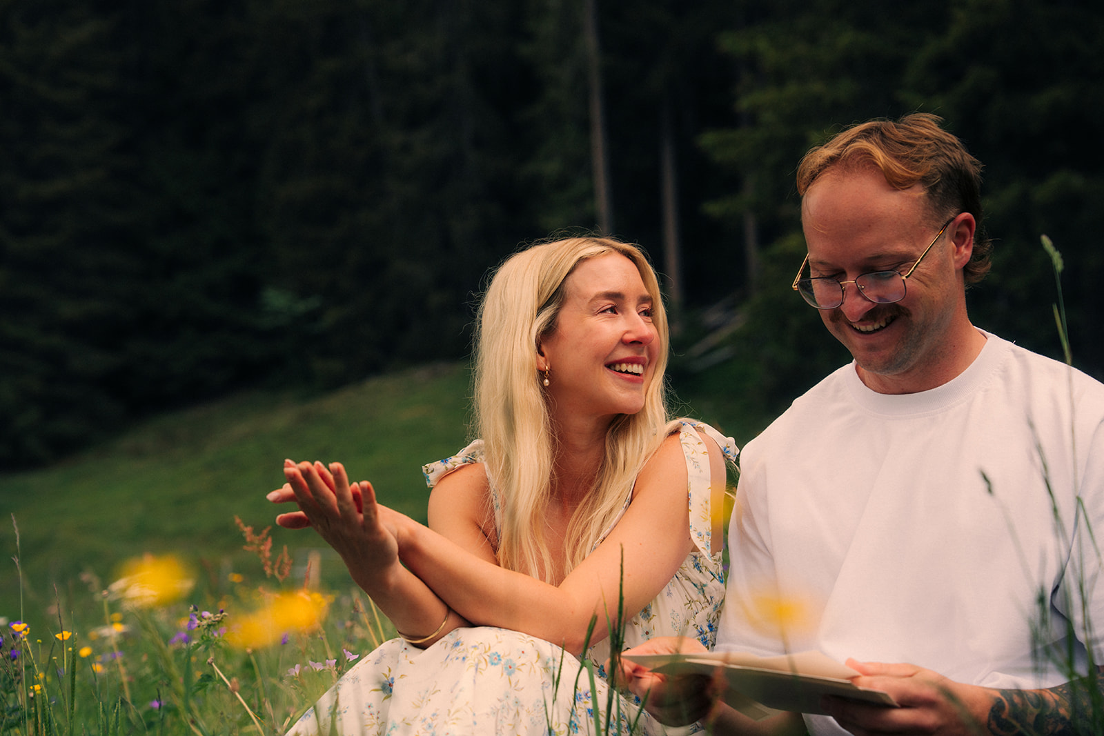 A cinematic photo of a couple reading letters near Wengen, Switzerland.