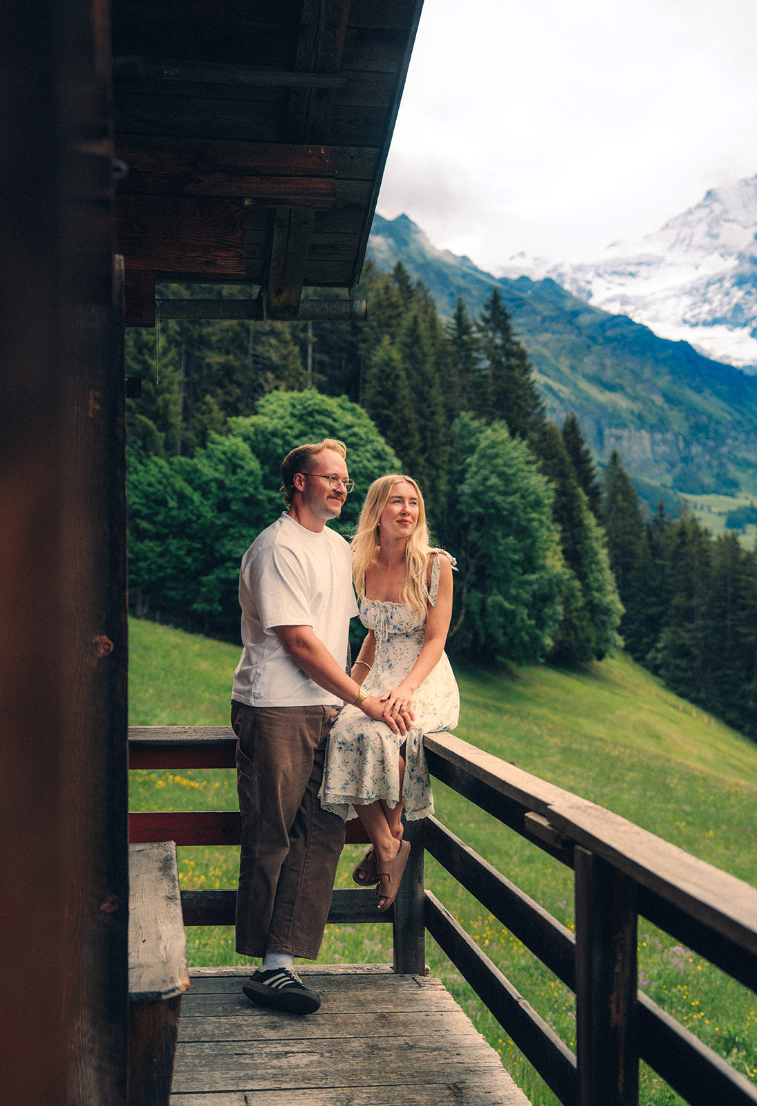 A cinematic photo of a couple posing near Wengen, Switzerland.