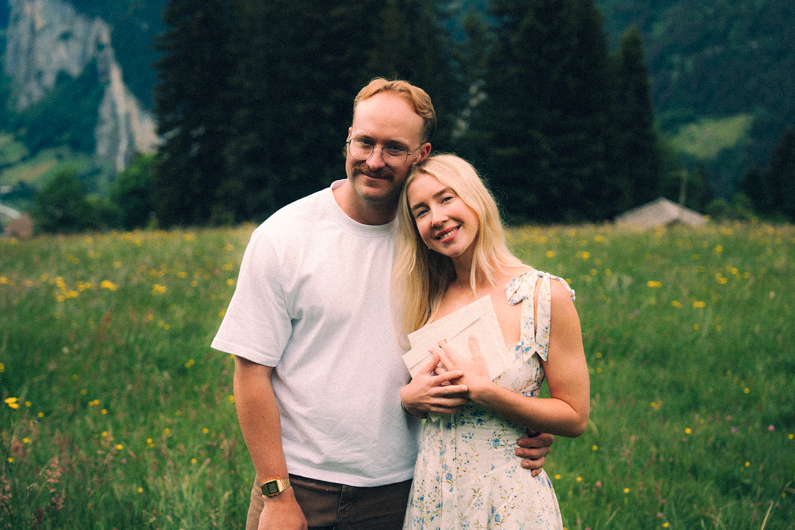 A cinematic photo of a couple posing near Wengen, Switzerland.