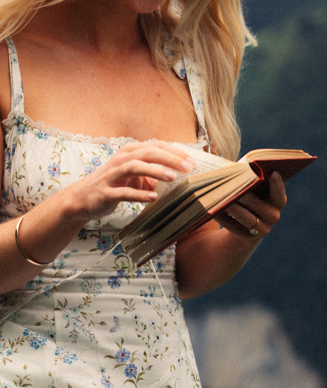 A cinematic detail shot of a bride with a book near Wengen, Switzerland with the Swiss Alps in the background.