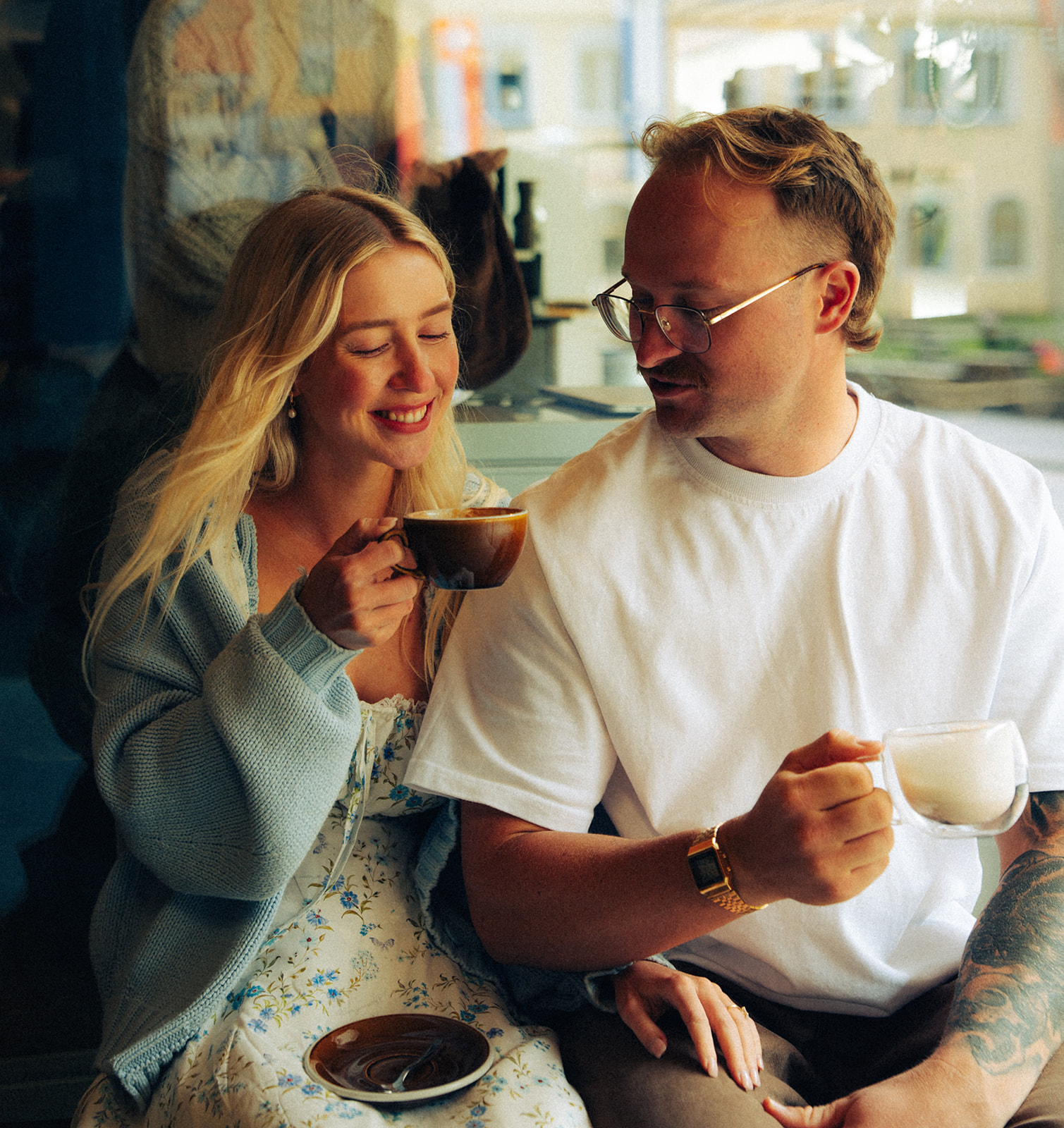 A cinematic photo of a couple posing in a cafe in Wengen, Switzerland.