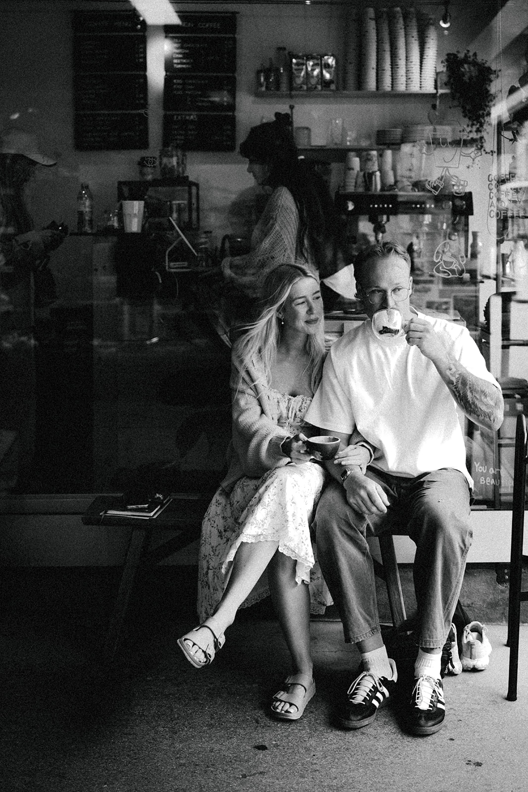 A cinematic photo of a couple posing in a cafe in Wengen, Switzerland.