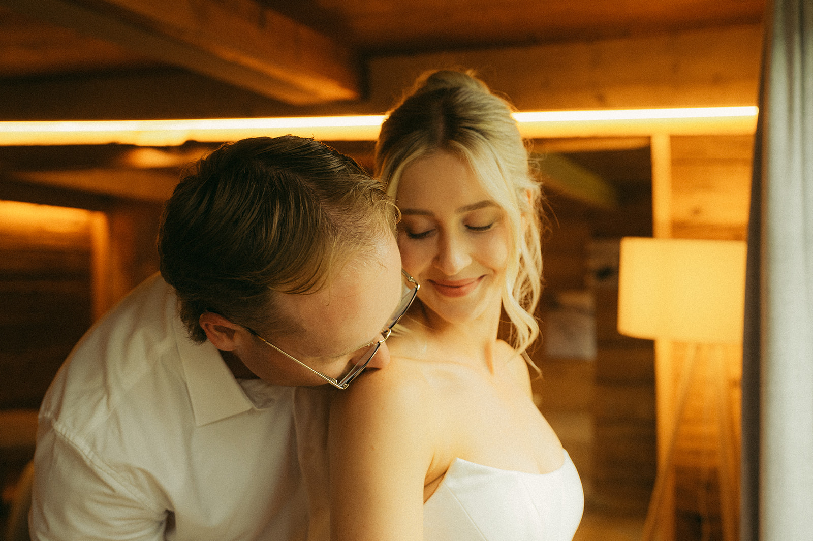 A cinematic photo of a couple getting ready in their cabin in Innertkirchen, Switzerland for their elopement.