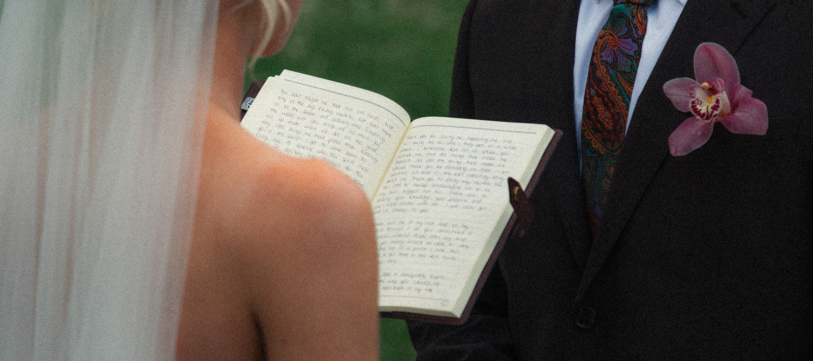 A cinematic detail shot of a bride with the vow book during her elopement in Rosenlaui, Switzerland.